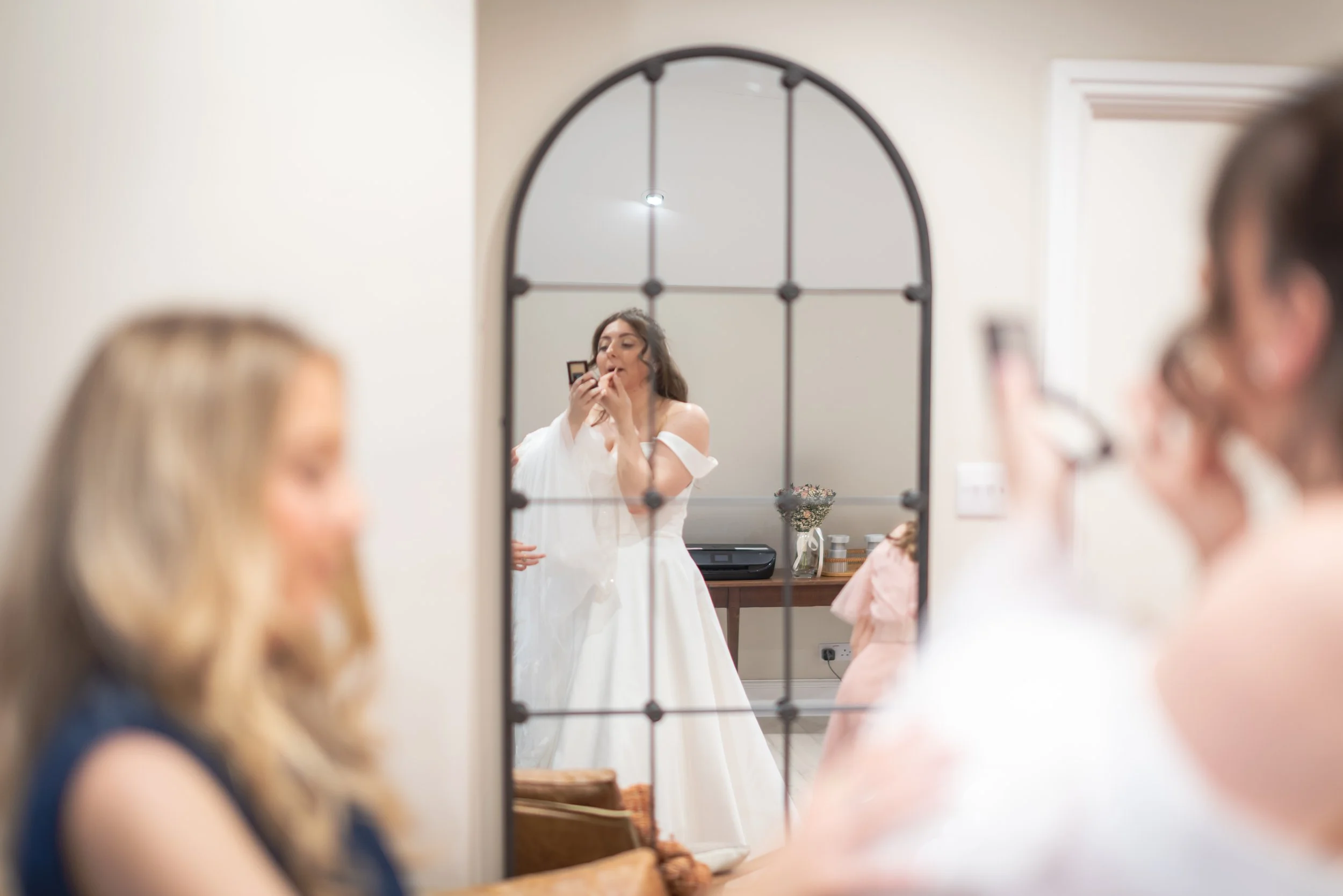 Bride Gemma looking into mirror during bridal prep before her intimate Roman Baths wedding