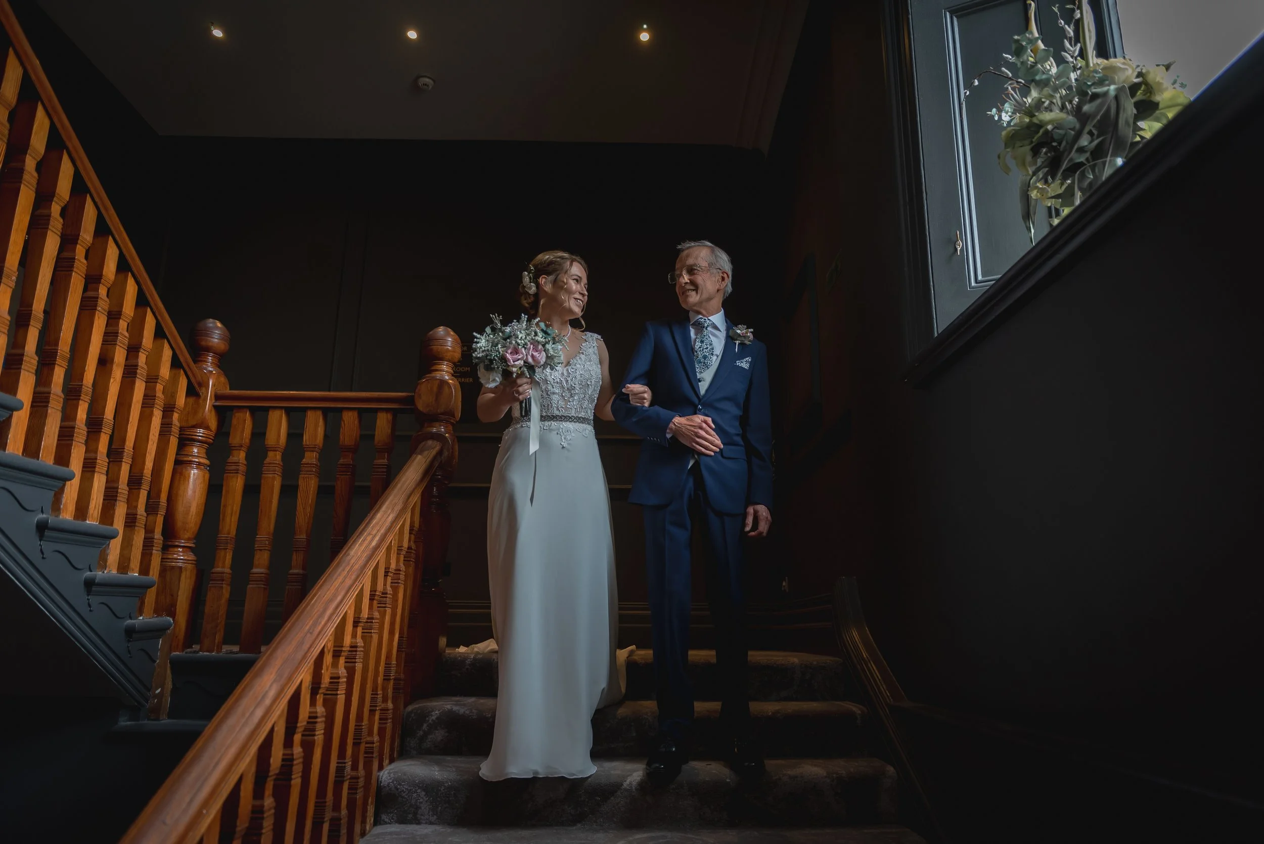Bride walking down the staircase with her father at Avon Gorge Hotel