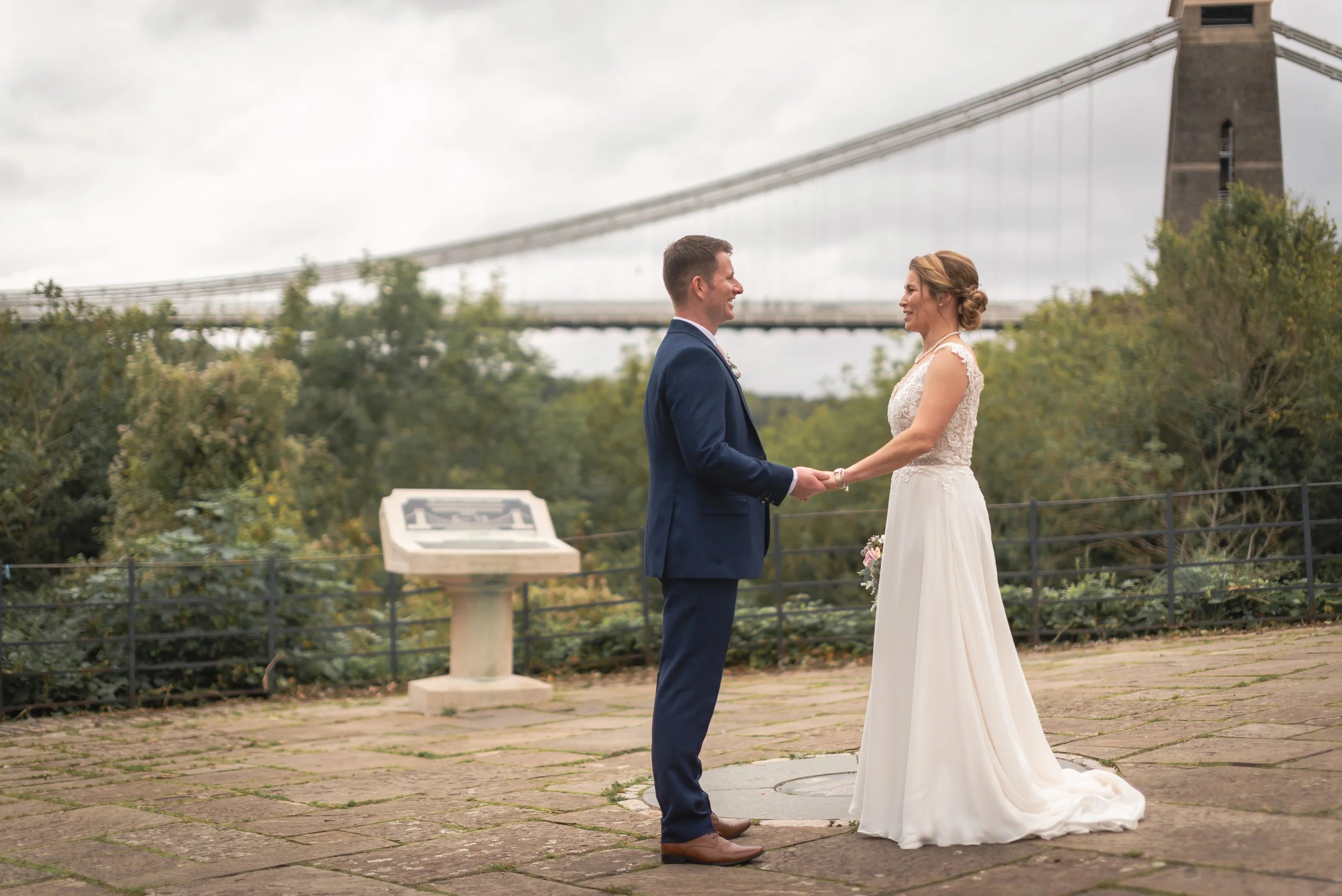 Couple dancing outside with Clifton Suspension Bridge view in distance