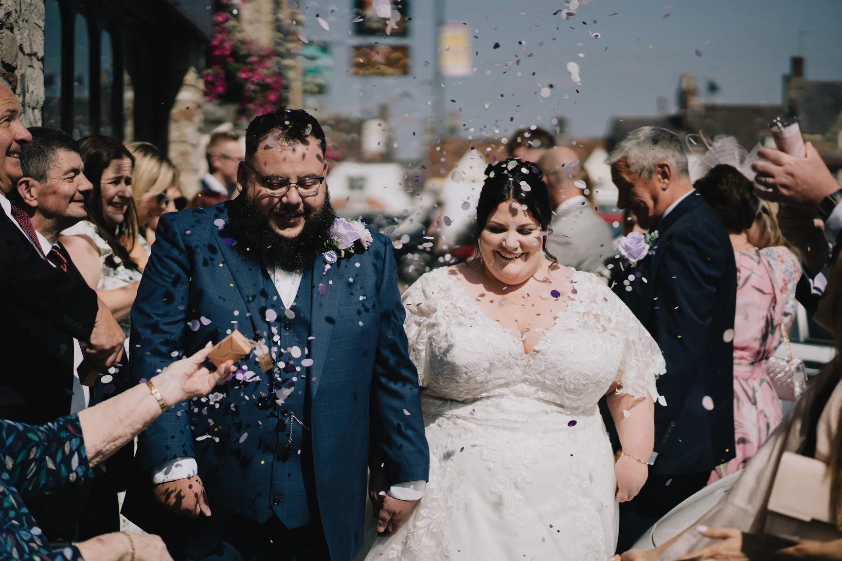 Bride and Groom being showered with confetti after their ceremony at Chipping Sodbury Town Hall taken by Bristol Wedding Photographer
