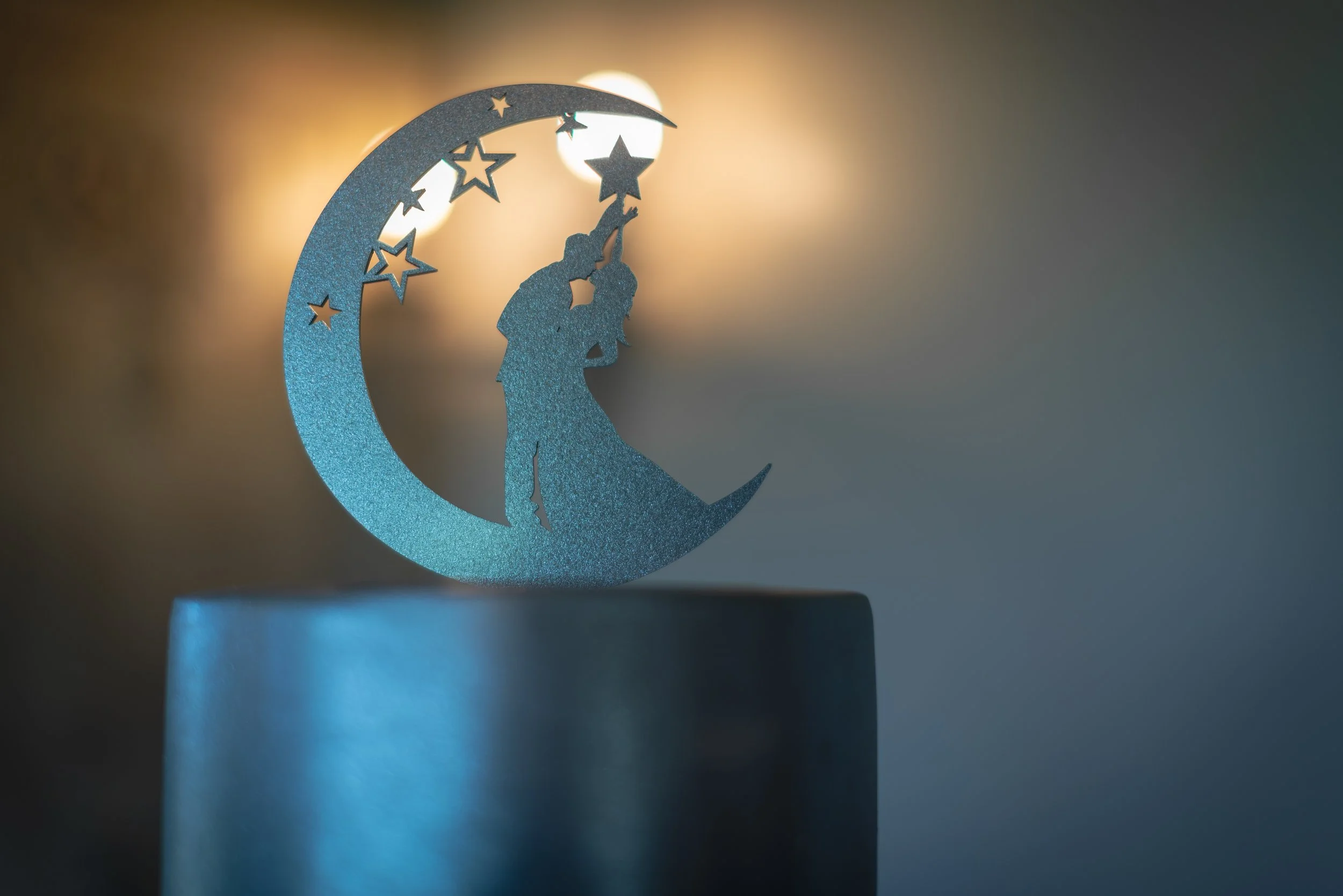 Cake topper on silver lined wedding cake ready for big day at Deer Park Hall