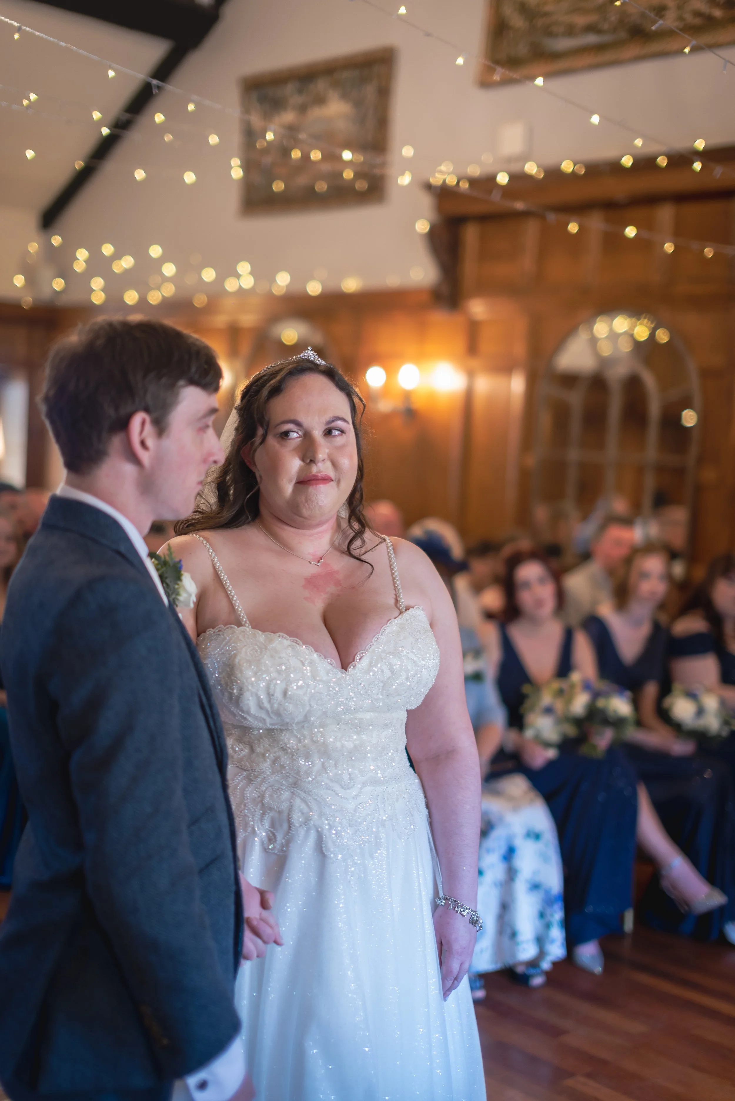 Bride giving the groom a cheeky smile during wedding ceremony at Deer Park Hall