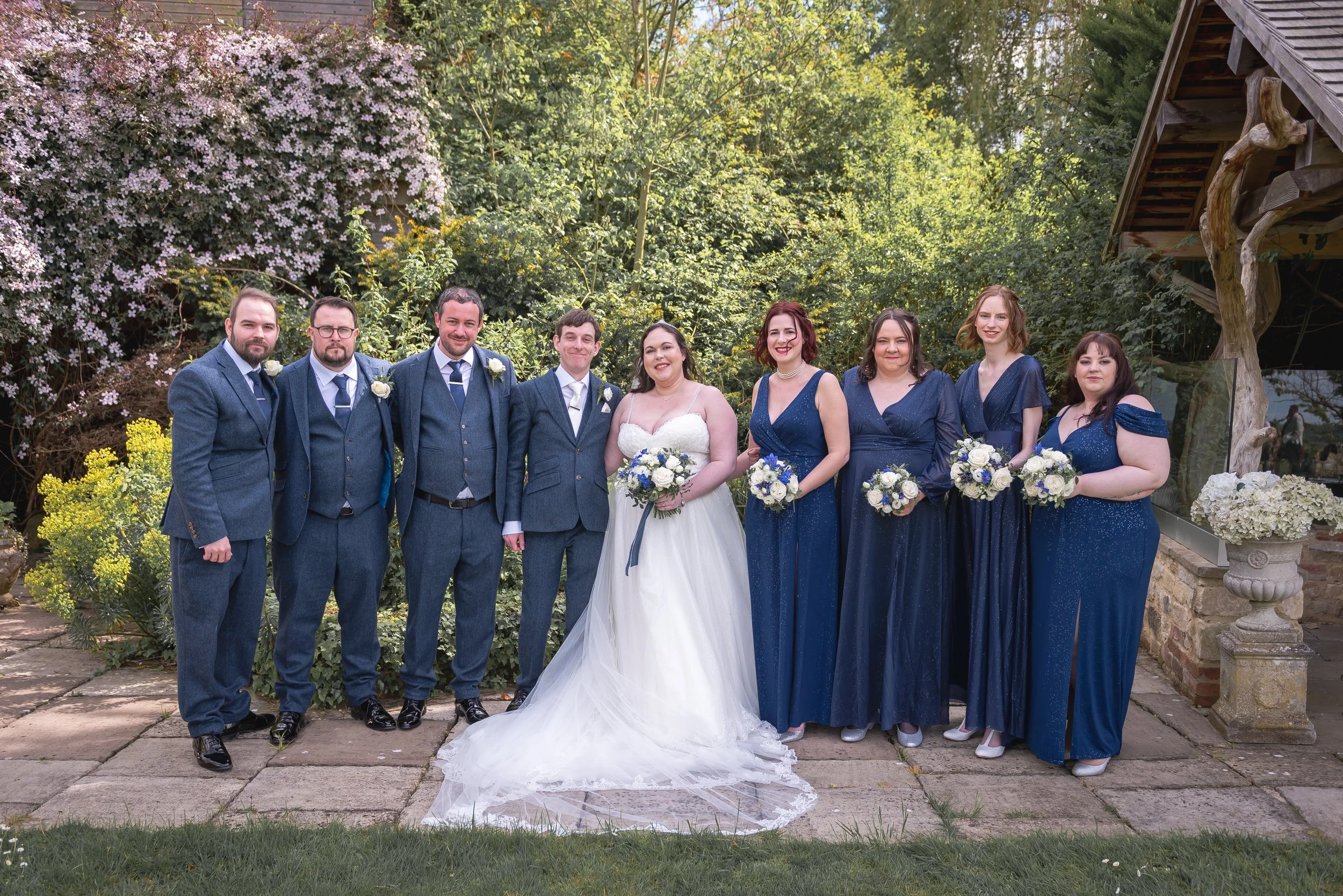Group shot if bridesmaids and groomsmen at a summer wedding at Deer Park Hall