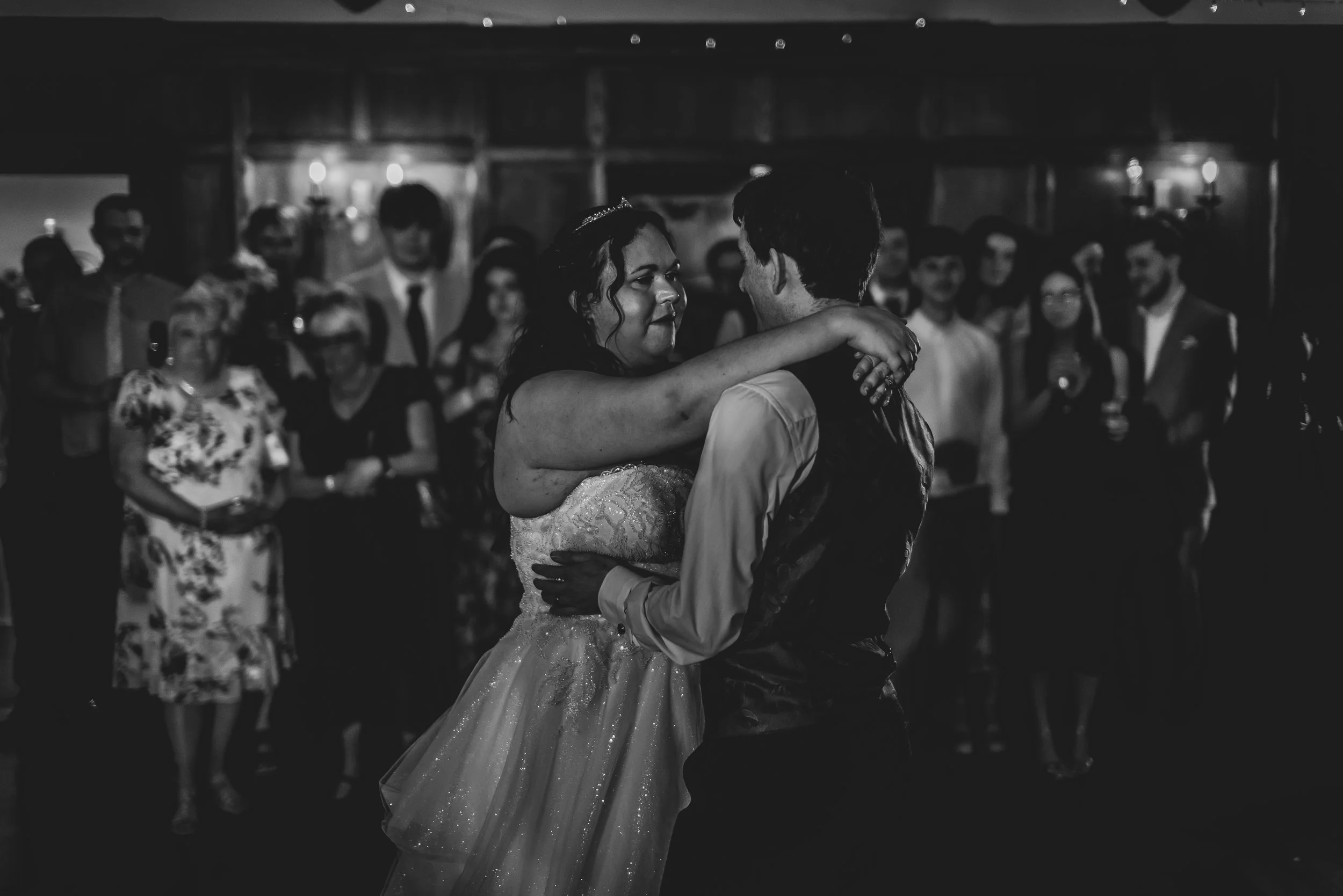 Black and white image of couple dancing with bride and groom at Deer Park Hall