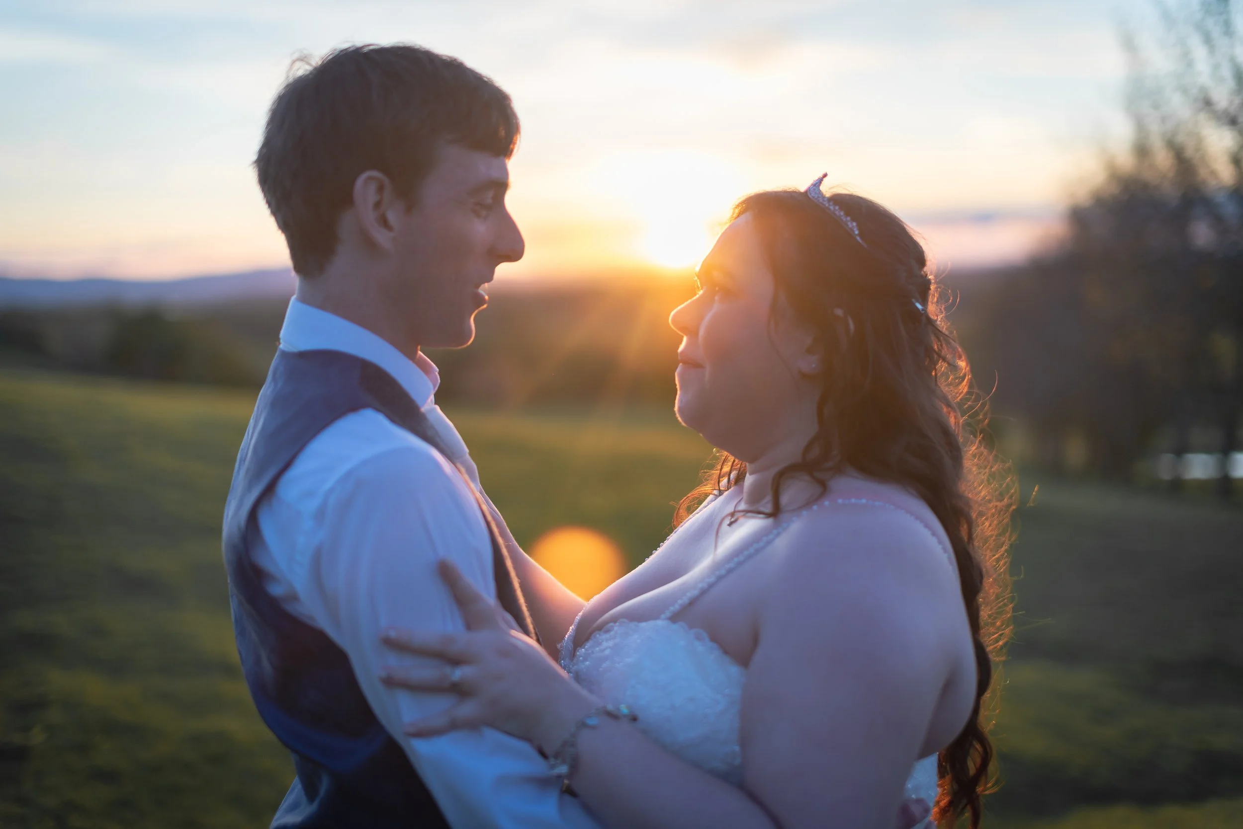 Young couple of the bride and groom with sunset in background at Deer Park Hall