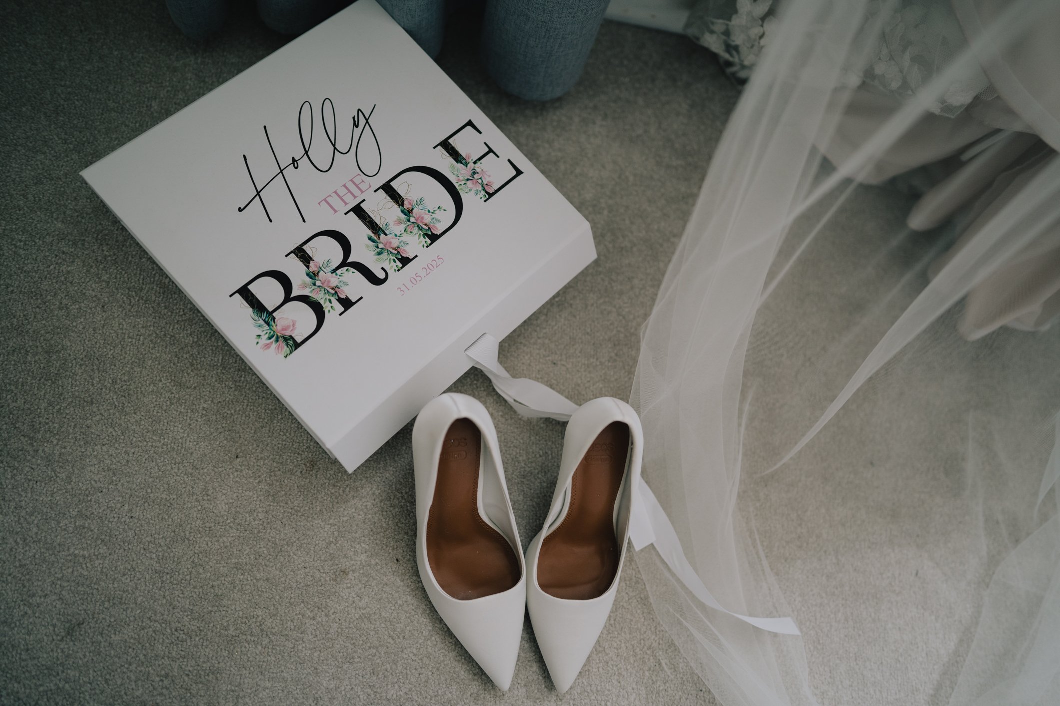 Flat lay of wedding shoes and accessories on rustic wooden floor, bridal details before ceremony at Somerset wedding