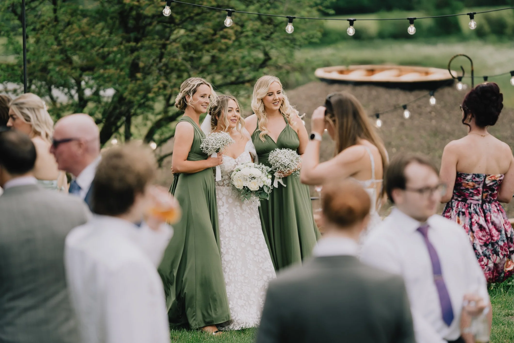 Bride and bridesmaids posing for polaroid photo