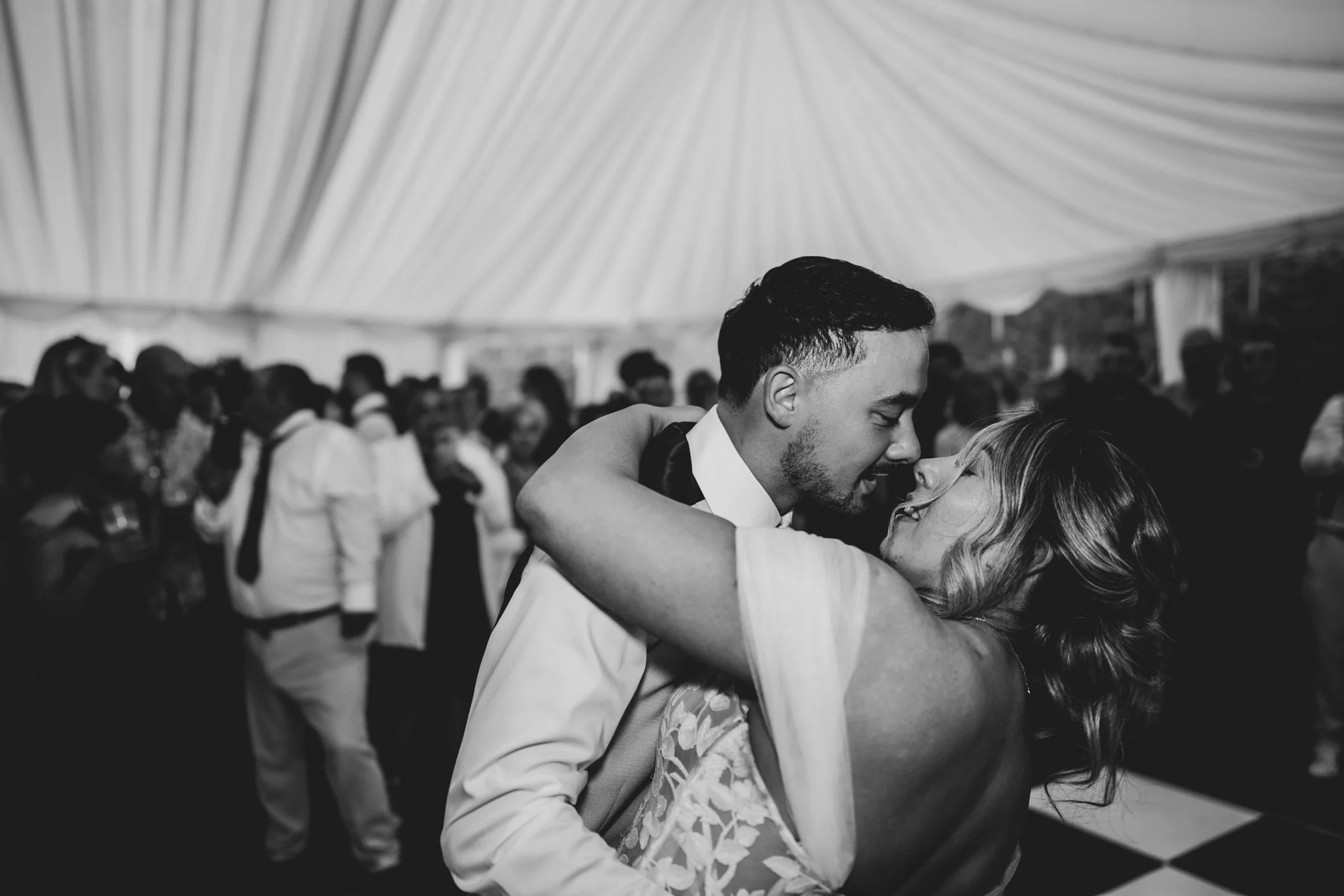 Bride and groom sharing their first dance inside rustic barn at Lapwing Farm, romantic moment under soft lighting