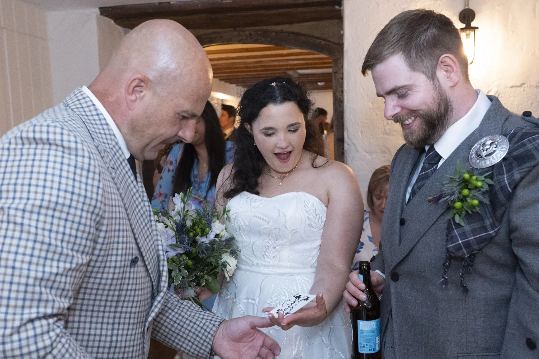 The modern conman performing magic trick with bride and groom at The Watermill