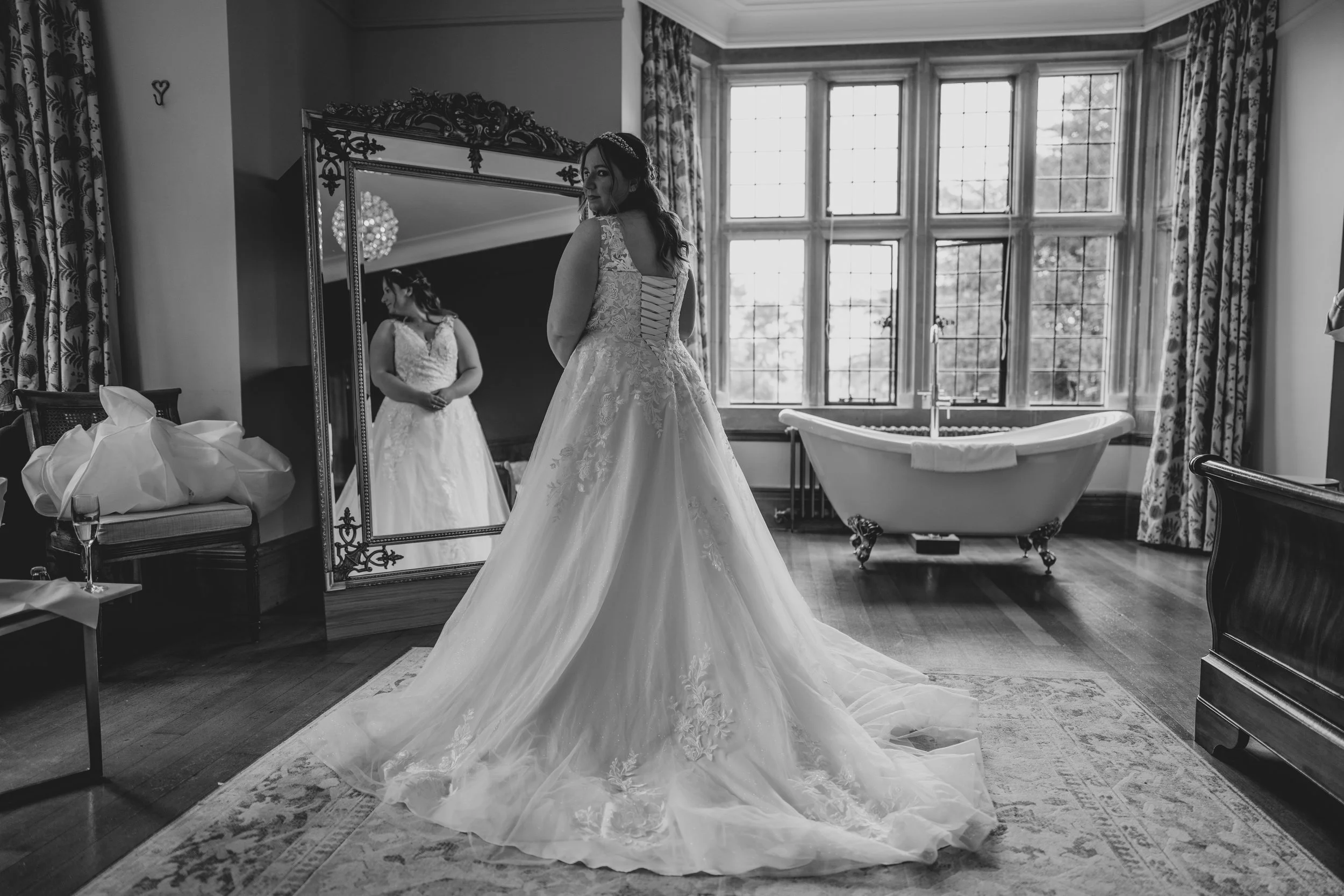 Bride in black and white with mirror in background at Coombe Lodge bridal suite