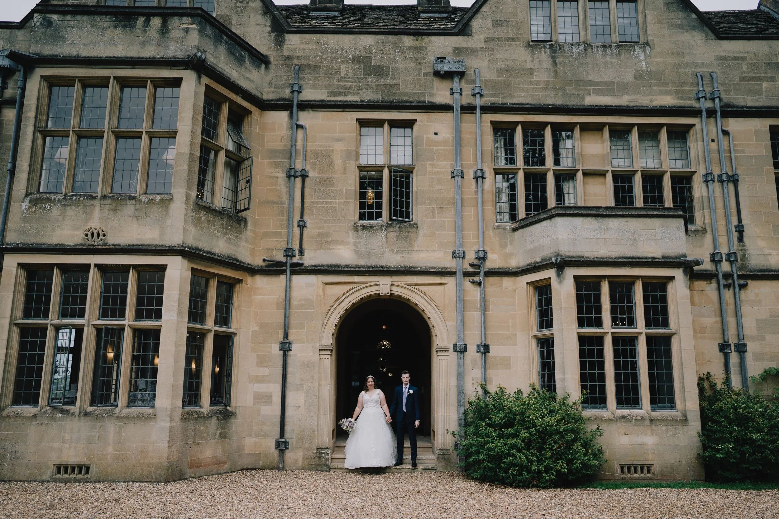 Bride and Groom standing outside Coombe Lodge after getting married
