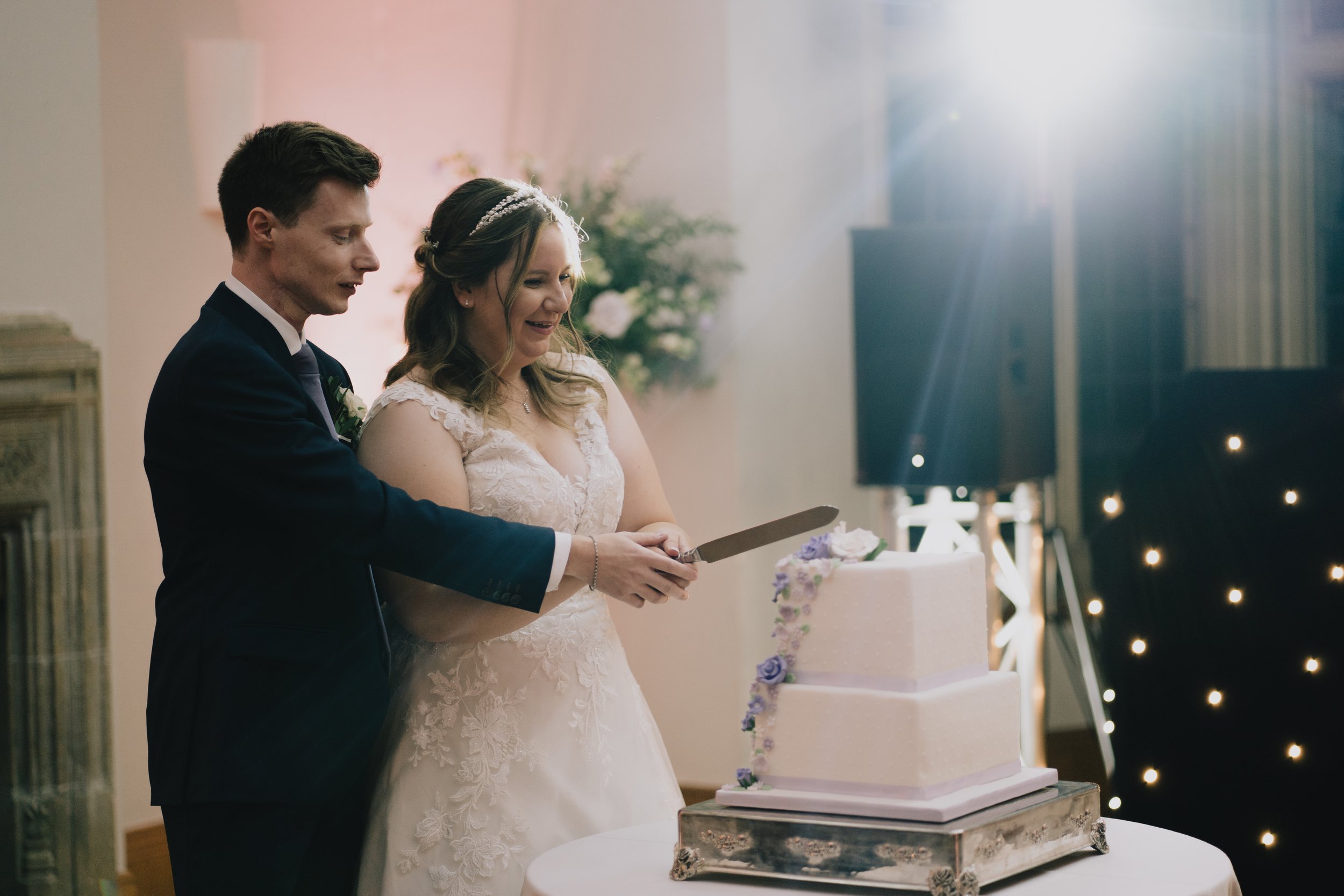 Bride and Groom about to cut the cake in the evening at Coombe Lodge