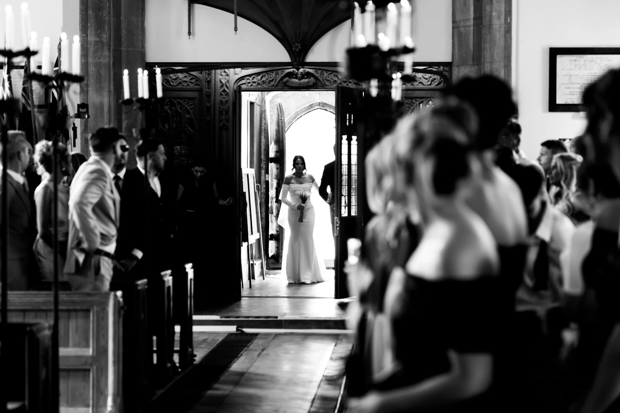 Black and white image of of bride ready to walk down aisle at chuch ceremony