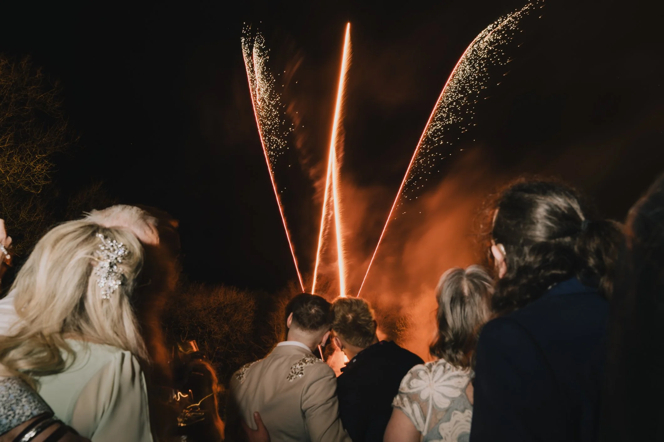Grooms watch on during firework display at Clearwell Castle