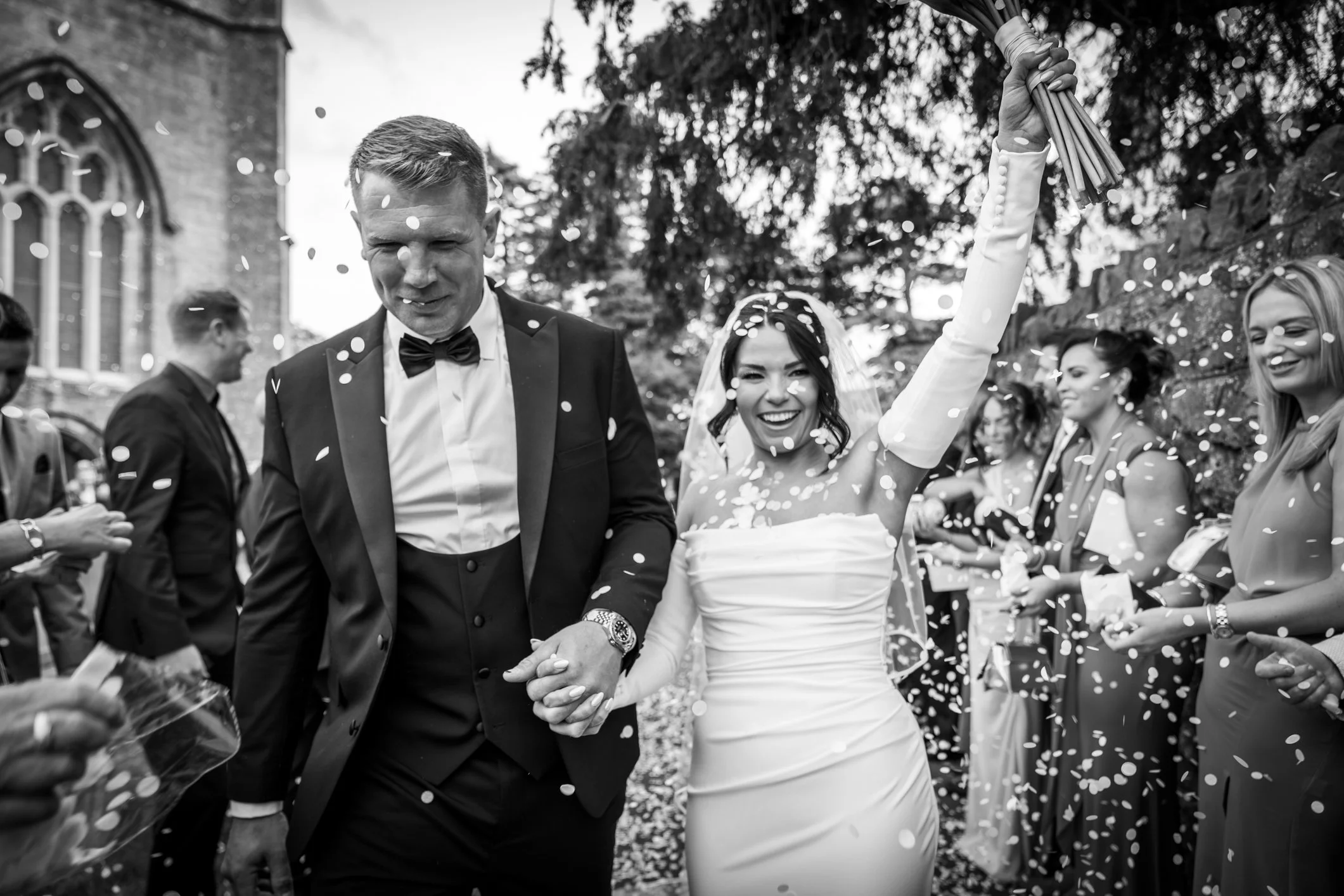 Bride and Groom walking away during confetti throw