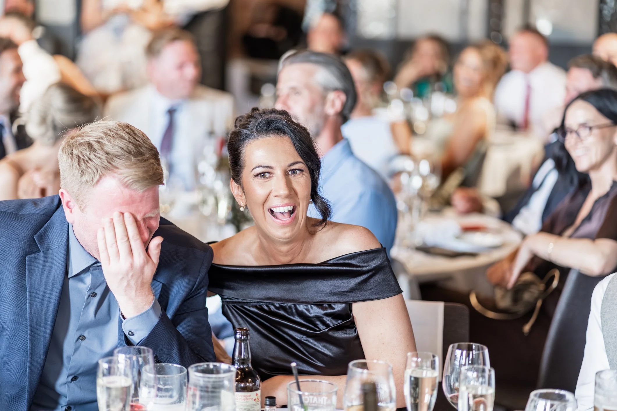 Wedding guest laughing during wedding speeches
