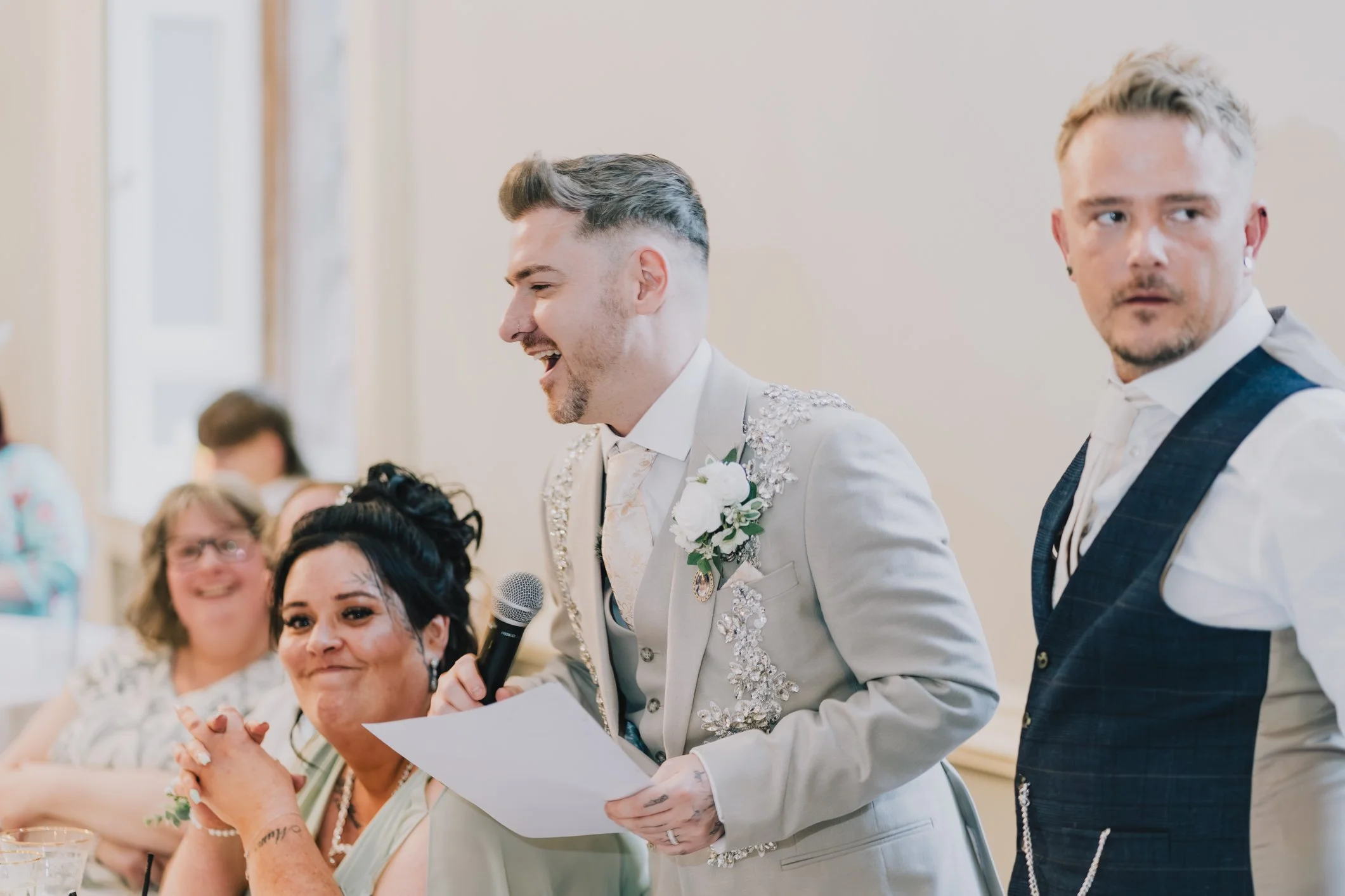 Groom laughs during his speech at wedding breakfast