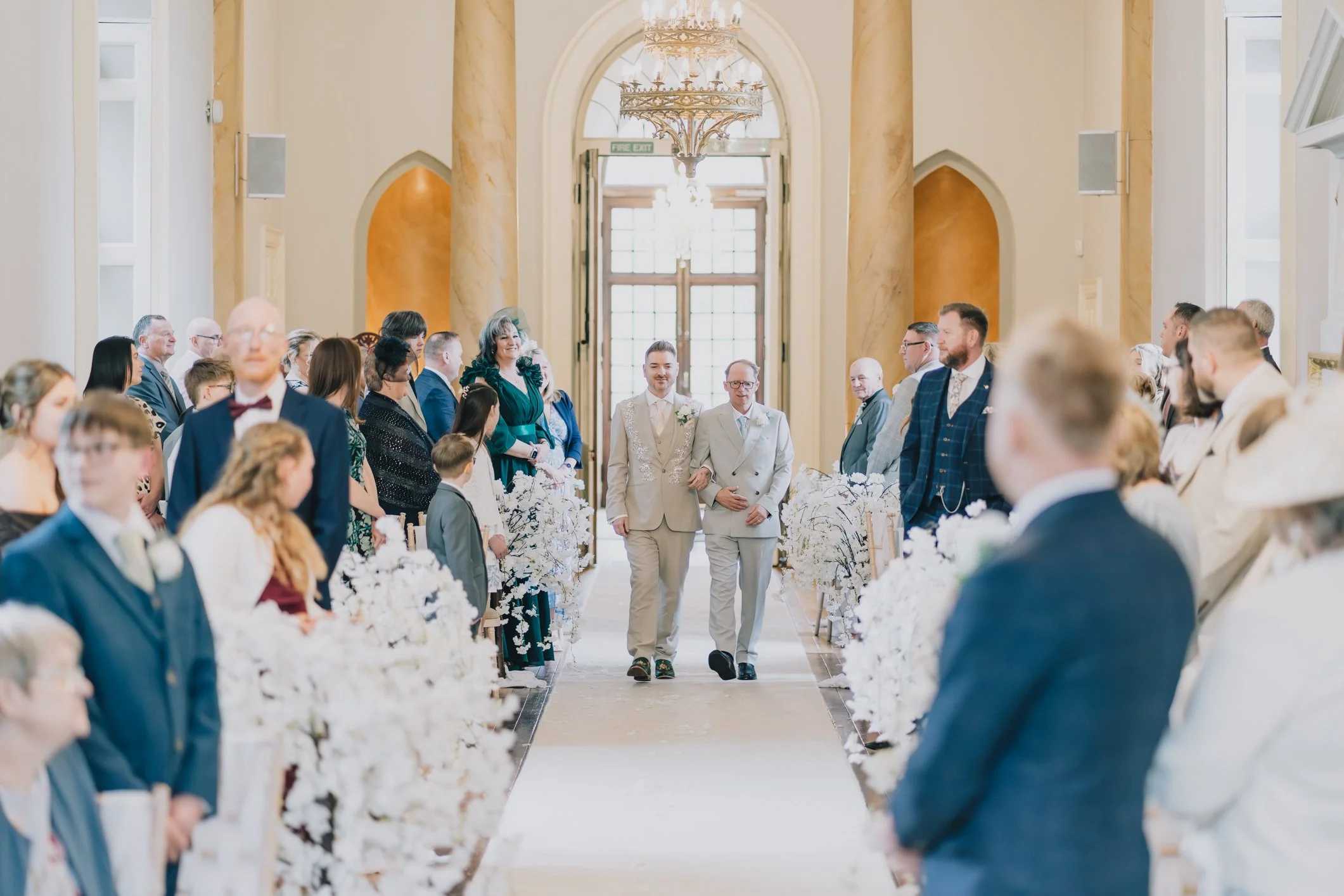 Groom walks down the aisle at Clearwell Castle