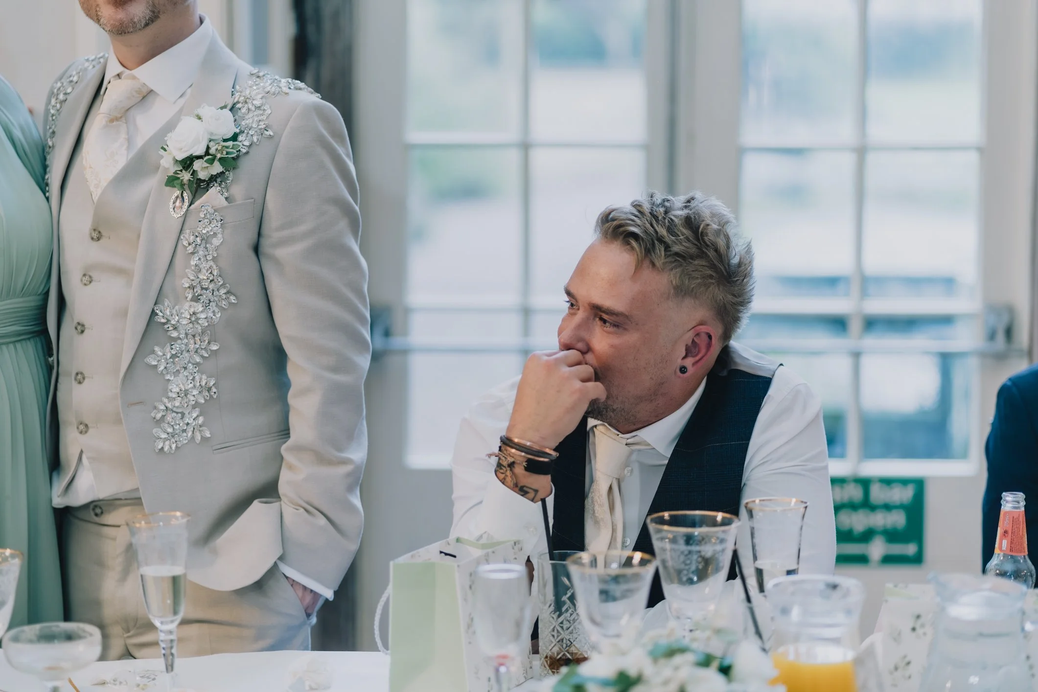 Groom smiling during service at his wedding breakfast in Gloucestershire