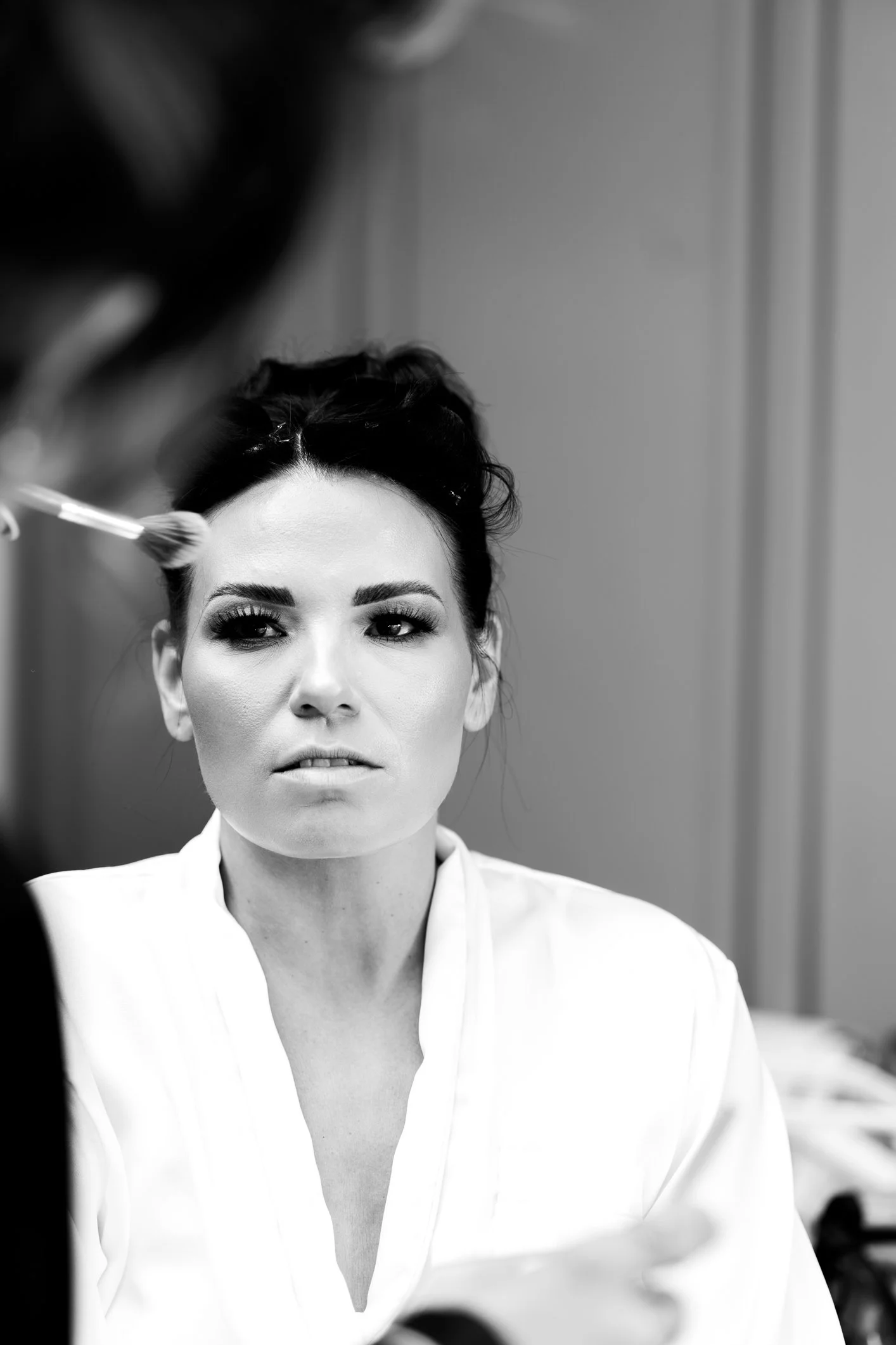 Black and white image of bride during prep at her home