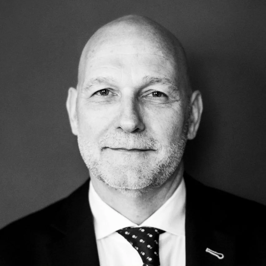 Headshot of smiling female tutor with short blonde hair wearing a lanyard.