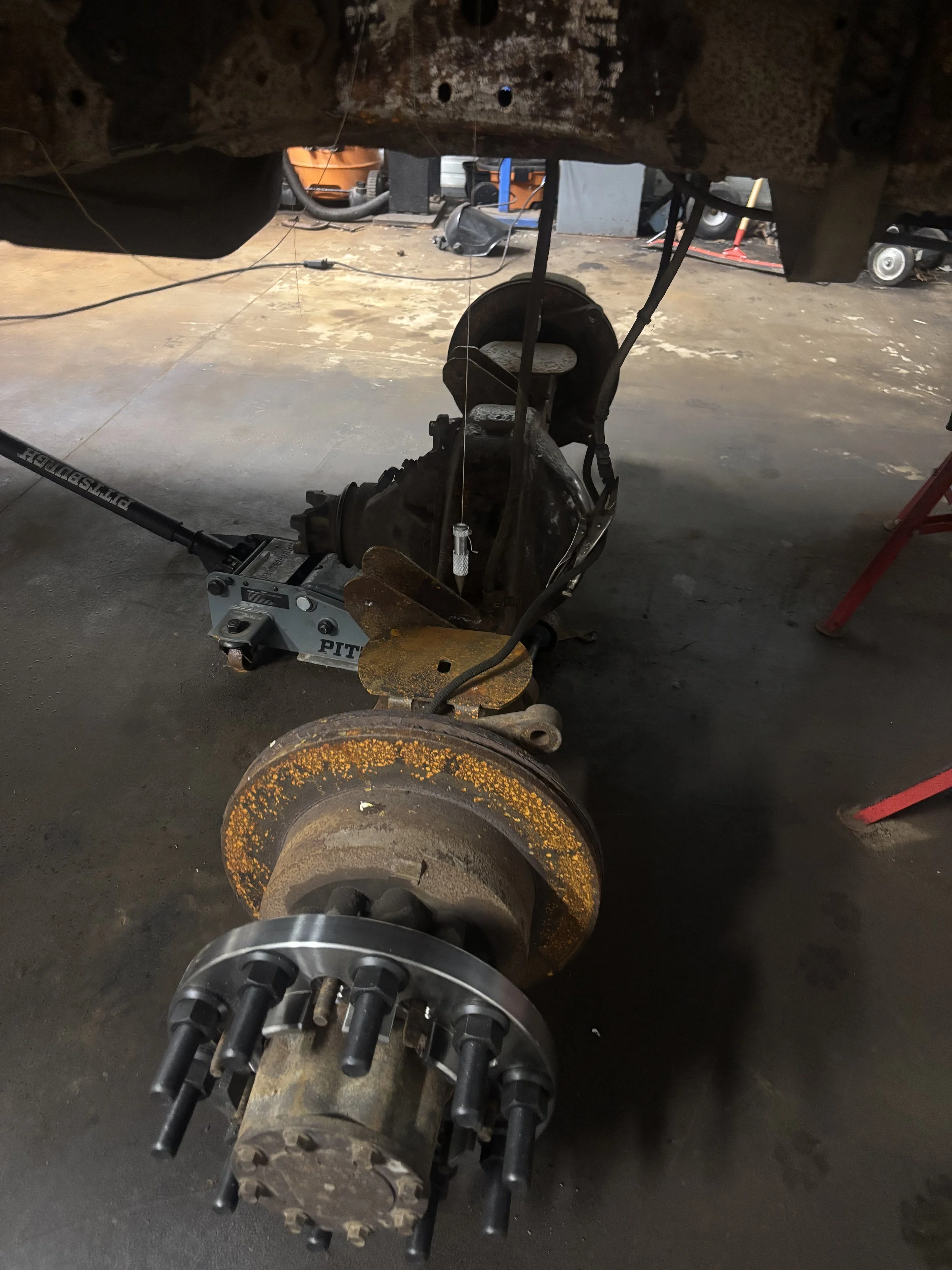 Custom F450 axle fabrication with 4 link suspension brackets and air bag mounts in Milford MI
