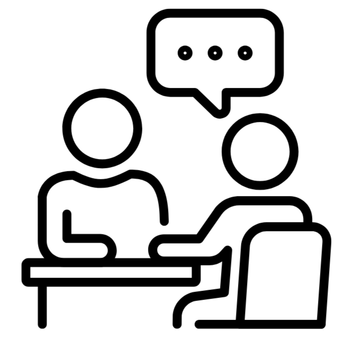 Two faceless figures seated across from each other at a table, engaged in conversation, with a speech bubble above one person.