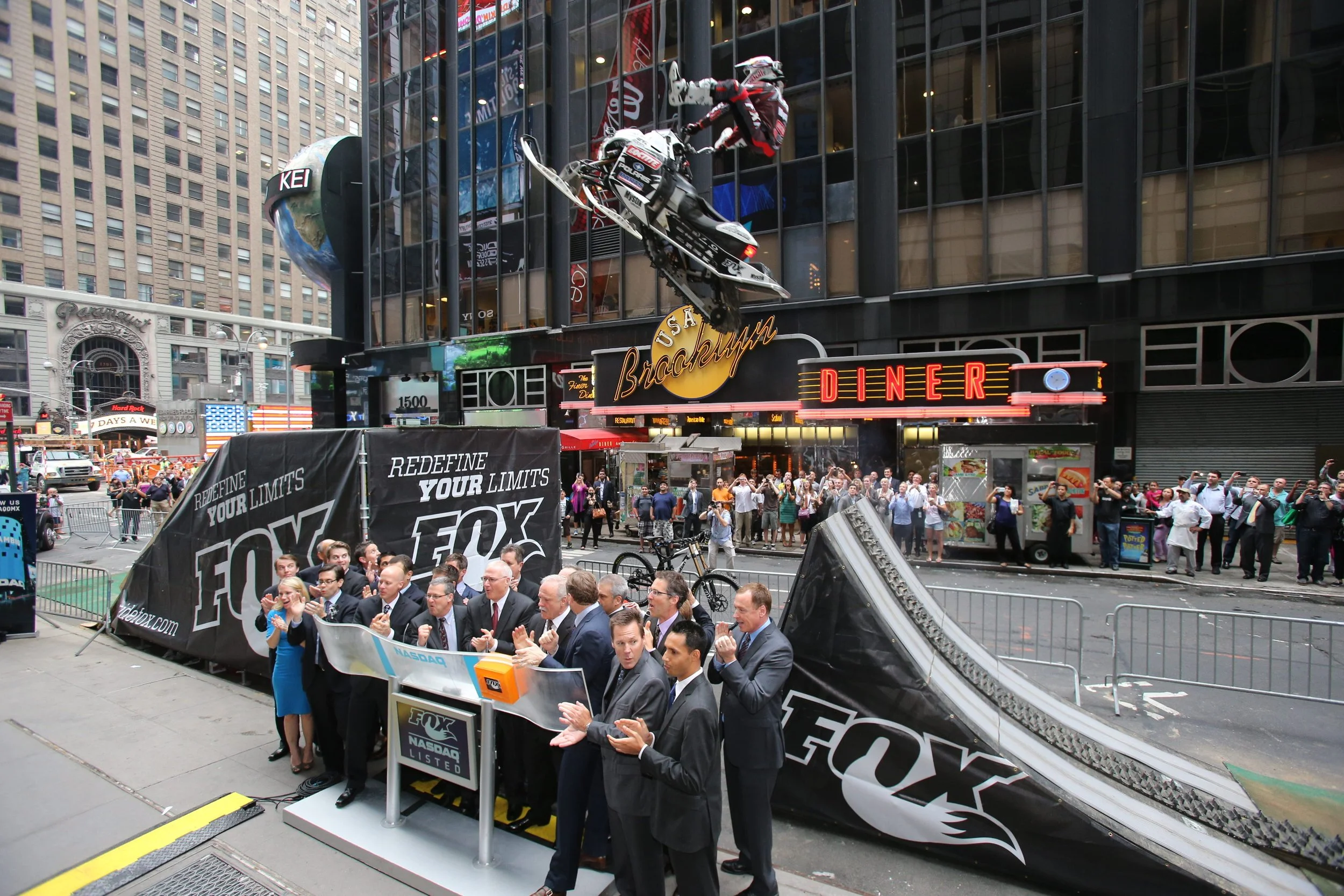 Levi Lavallee jumping over the FOX Factory Team in Times Square on his snowmobile on August 8, 2013 while ringing the NASDAQ Opening Bell for their IPO.