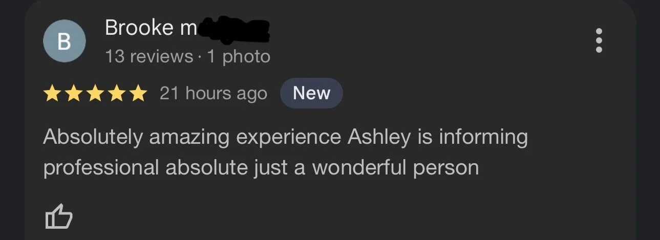 Google review section showing a 5-star rating, a reviewer named Brooke with one photo, and a positive comment praising Ashley for providing an amazing and professional experience.