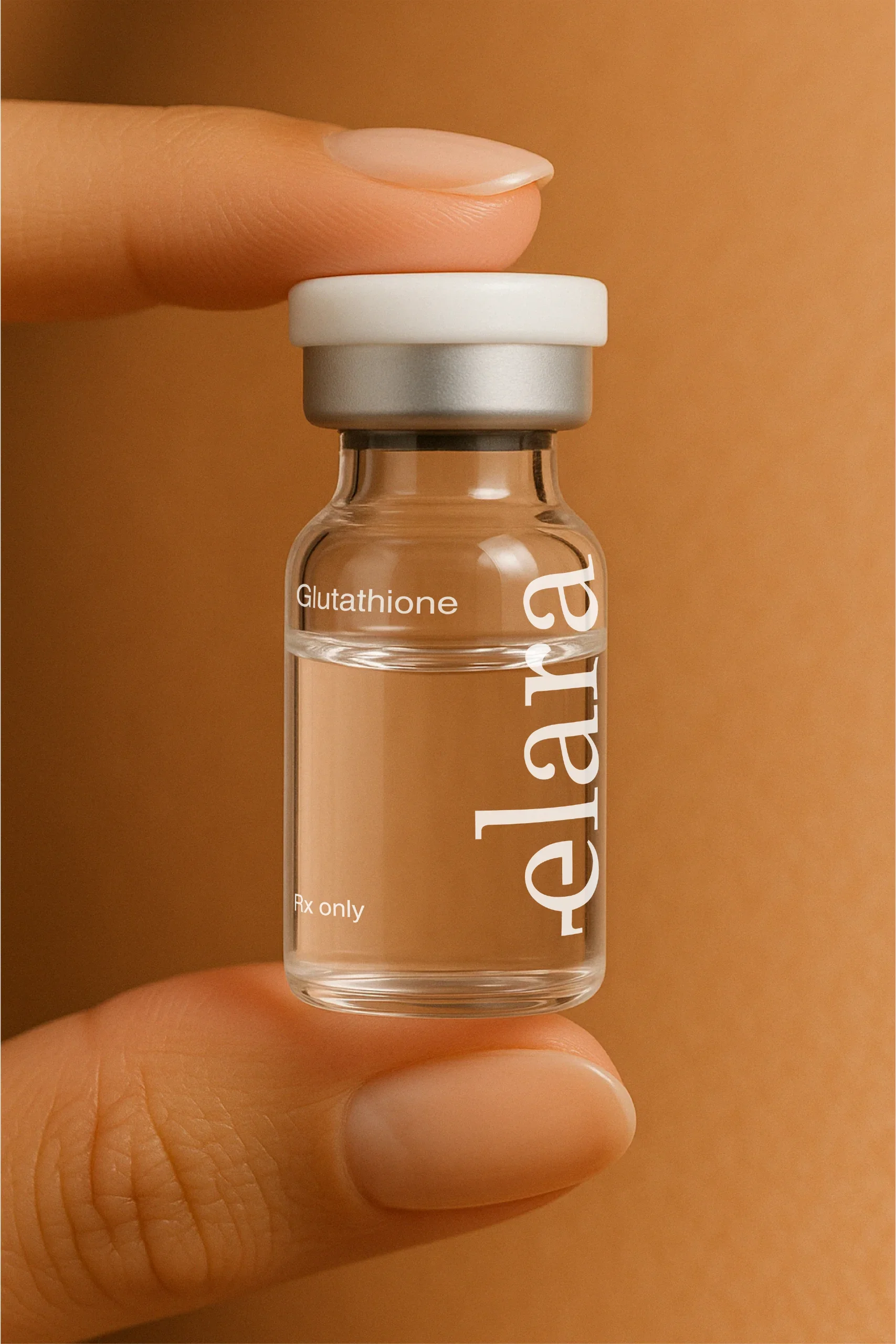A small glass vial labeled 'Elara' with the word 'Glutathione' on it, held between a person's thumb and index finger, with a beige background.