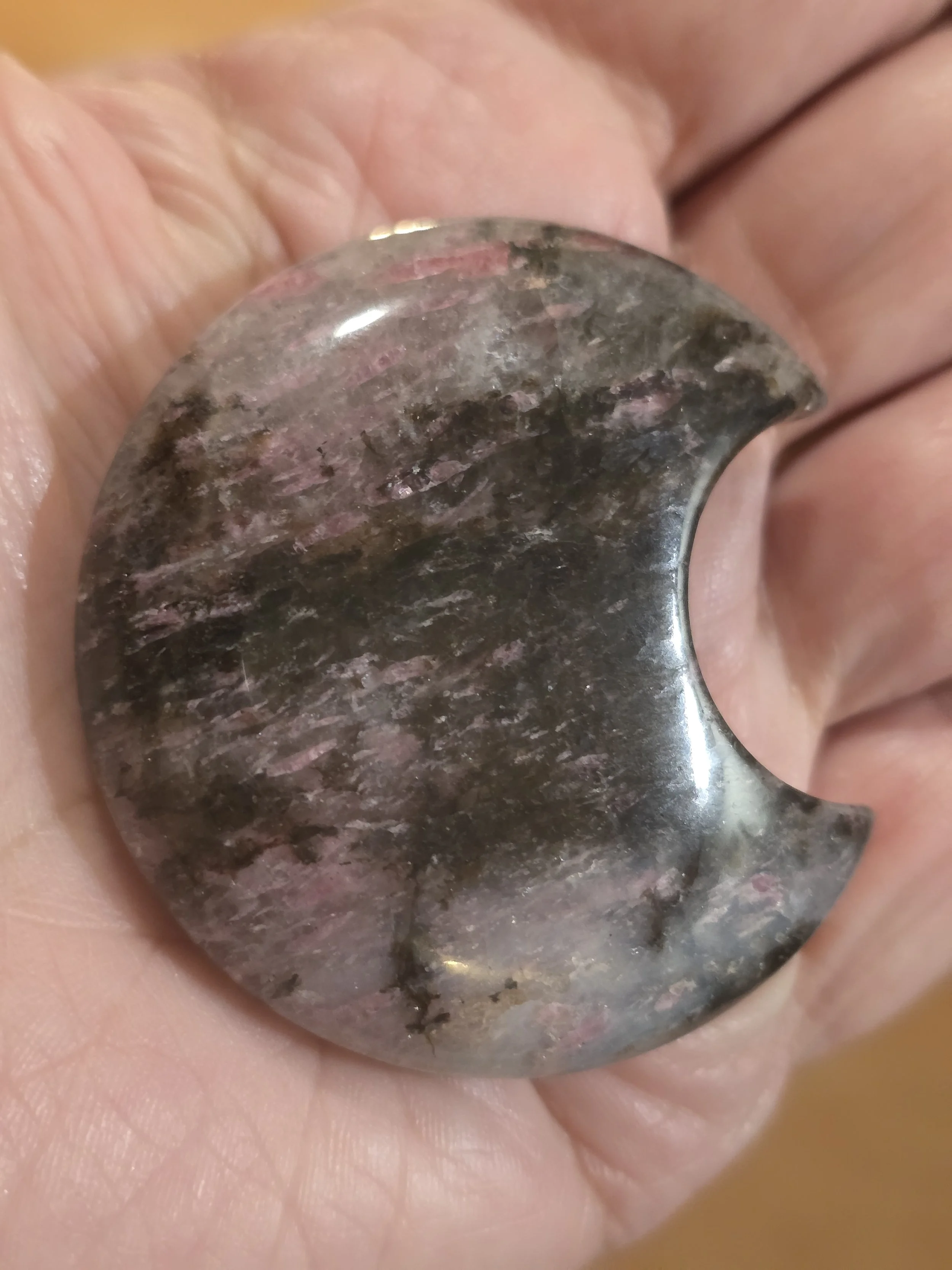 rhodonite moon in hand.jpg
