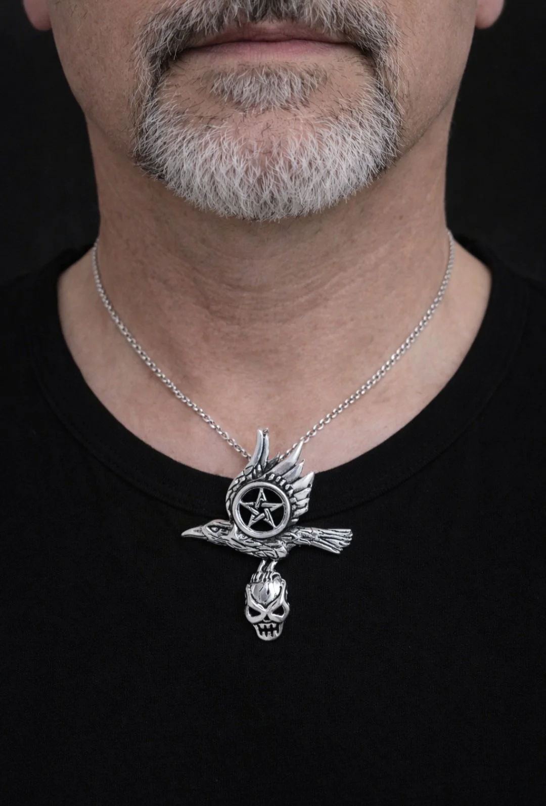 guy wearing bird with skull pendant.jpg