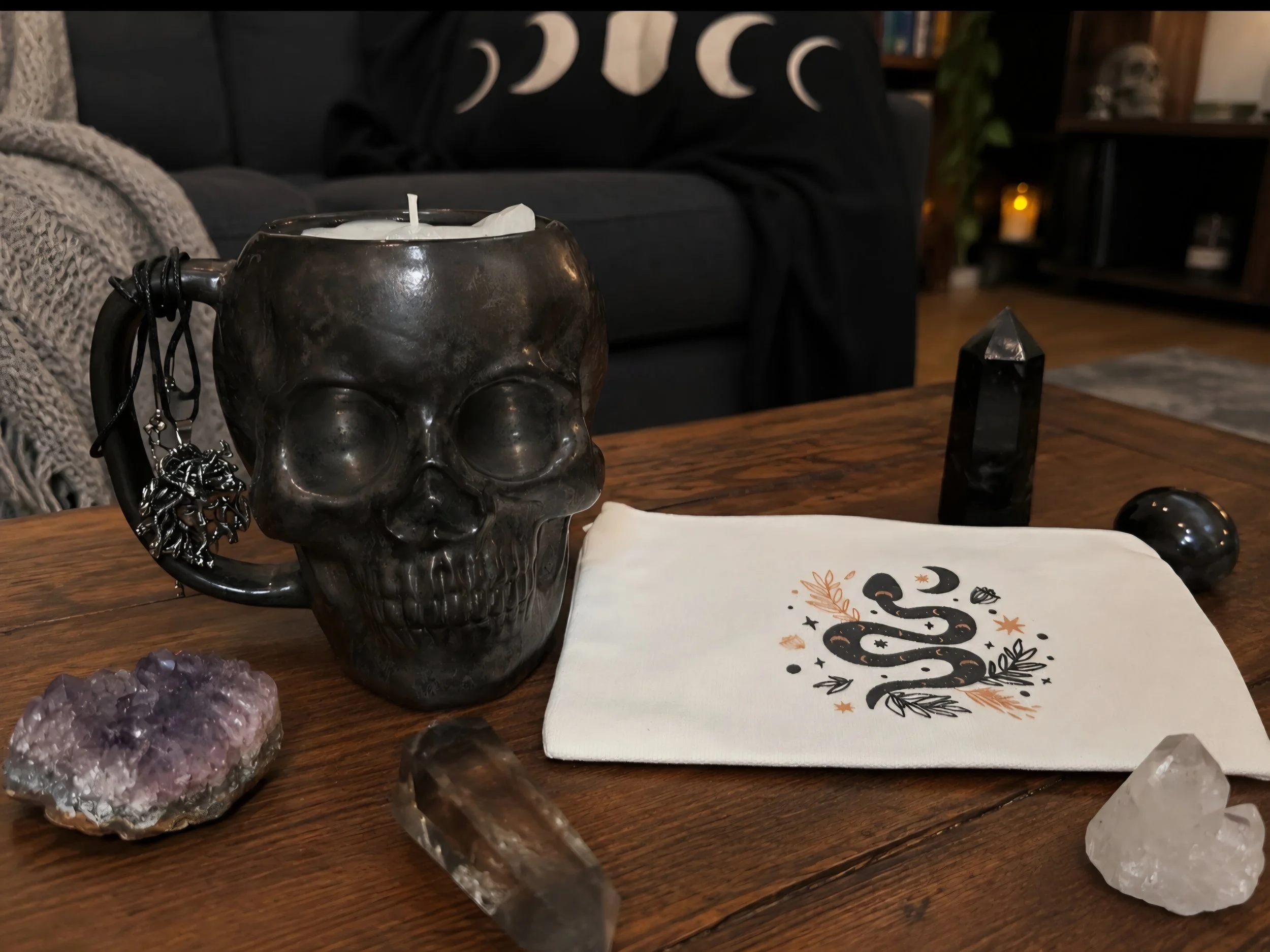 skull candle woth medusa necklace on table.jpg