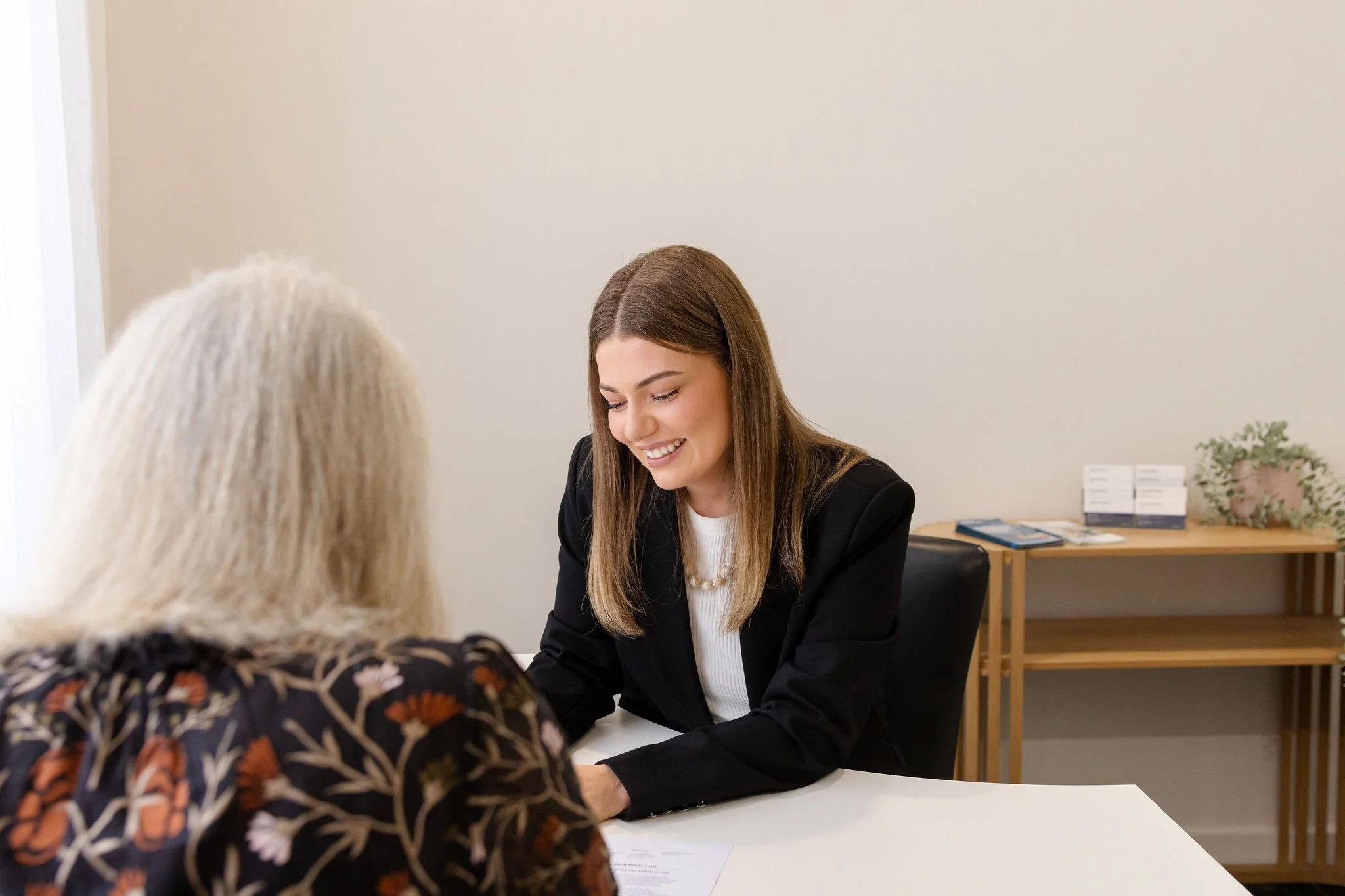 Savannah Keightley, Lawyer speaking with an older client in the office