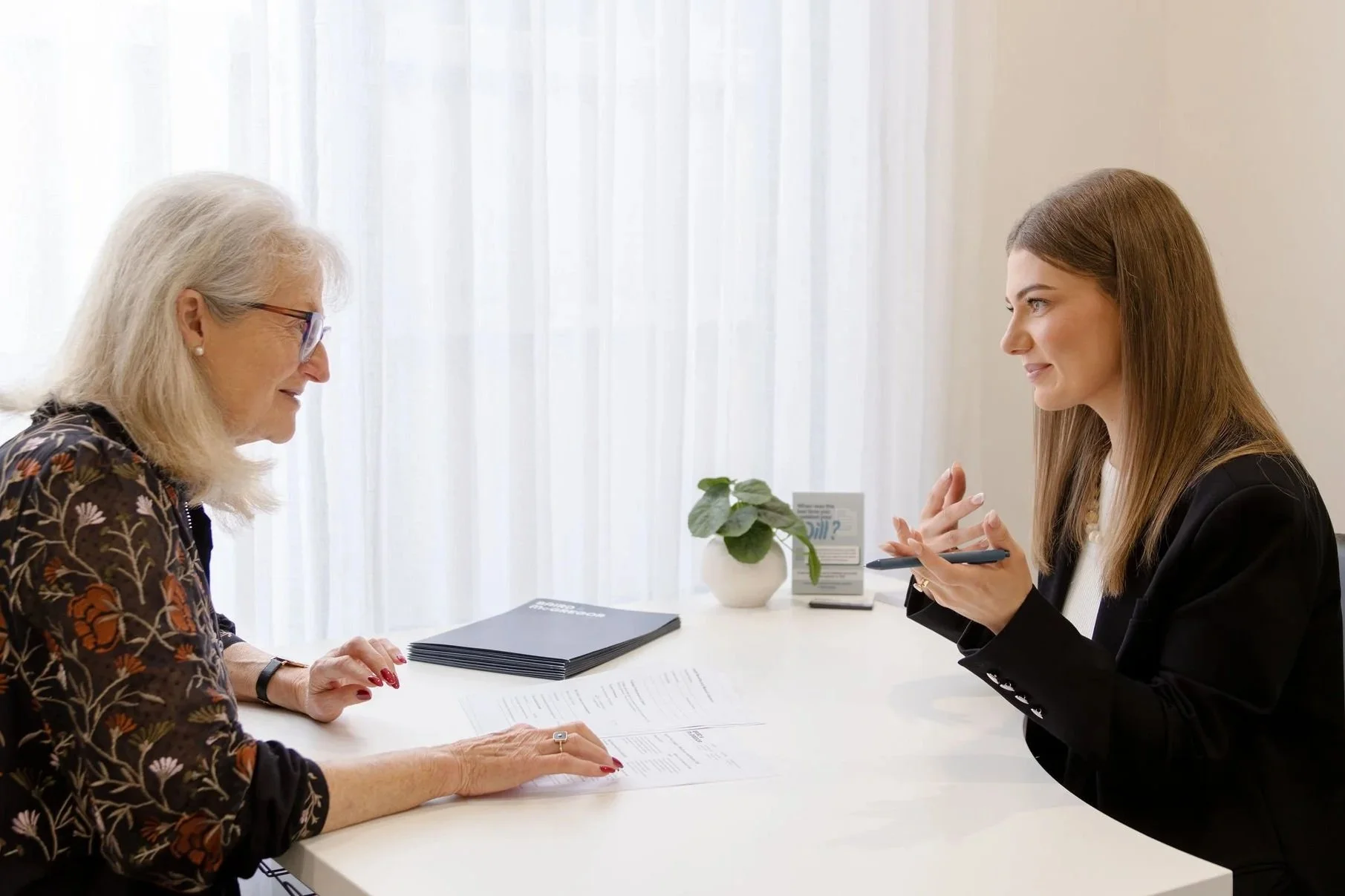 Savannah Keightley, Lawyer speaking with an older client at a desk