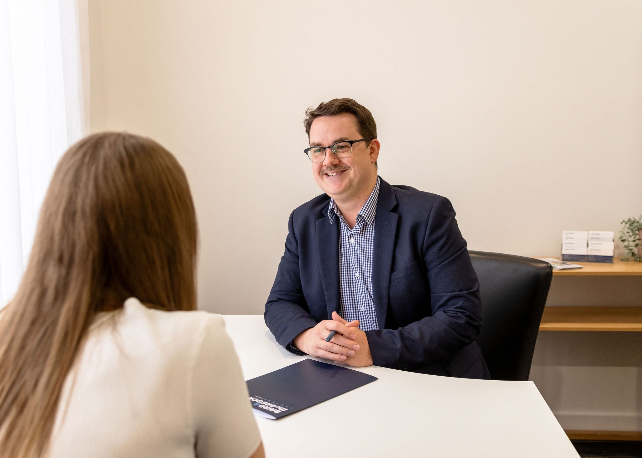 Ben Wilkie, Lawyer meeting with a client in an office