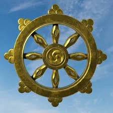 Golden Dharma wheel with blue sky background.