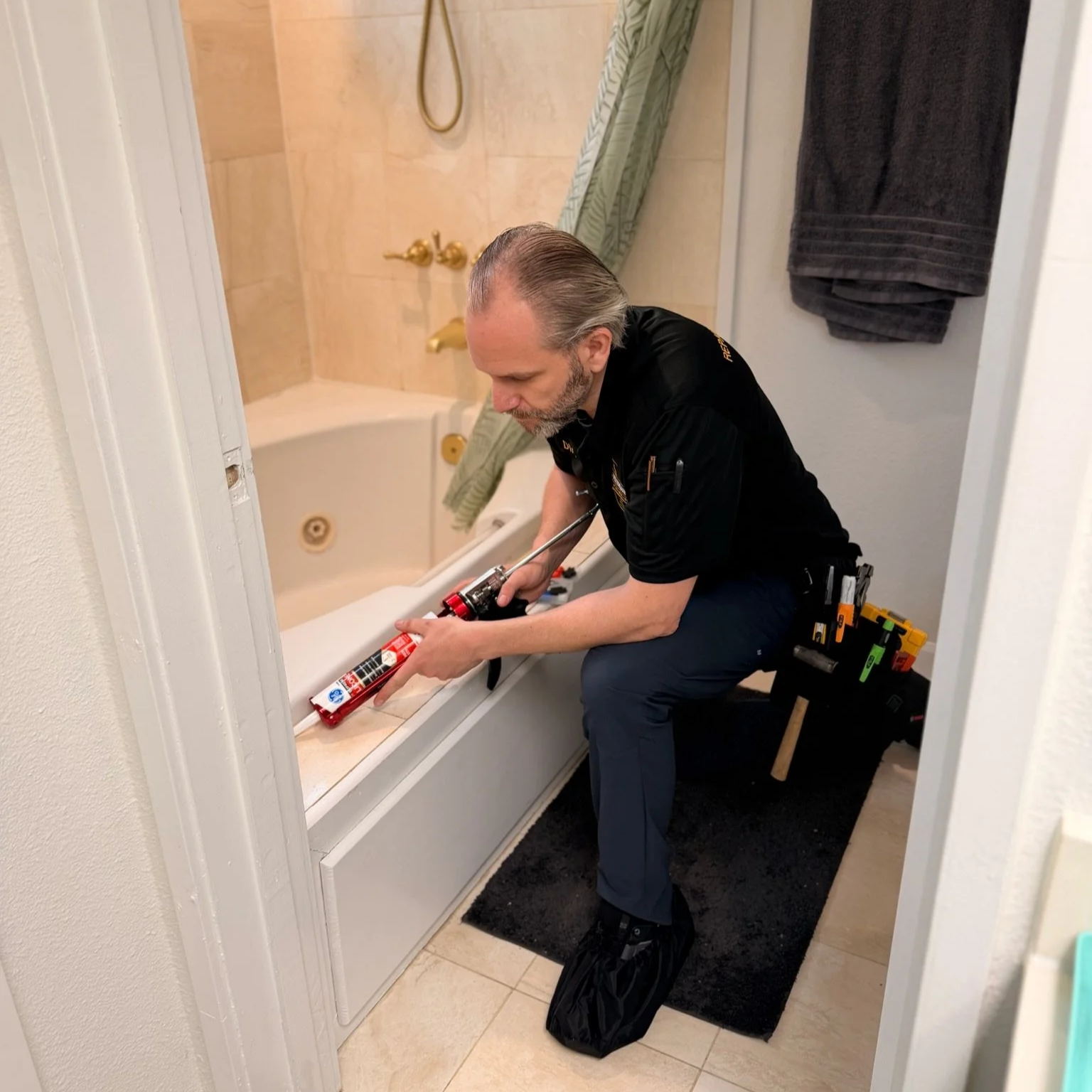 handyman fixing shower and bathroom and caulking  in Queen Anne