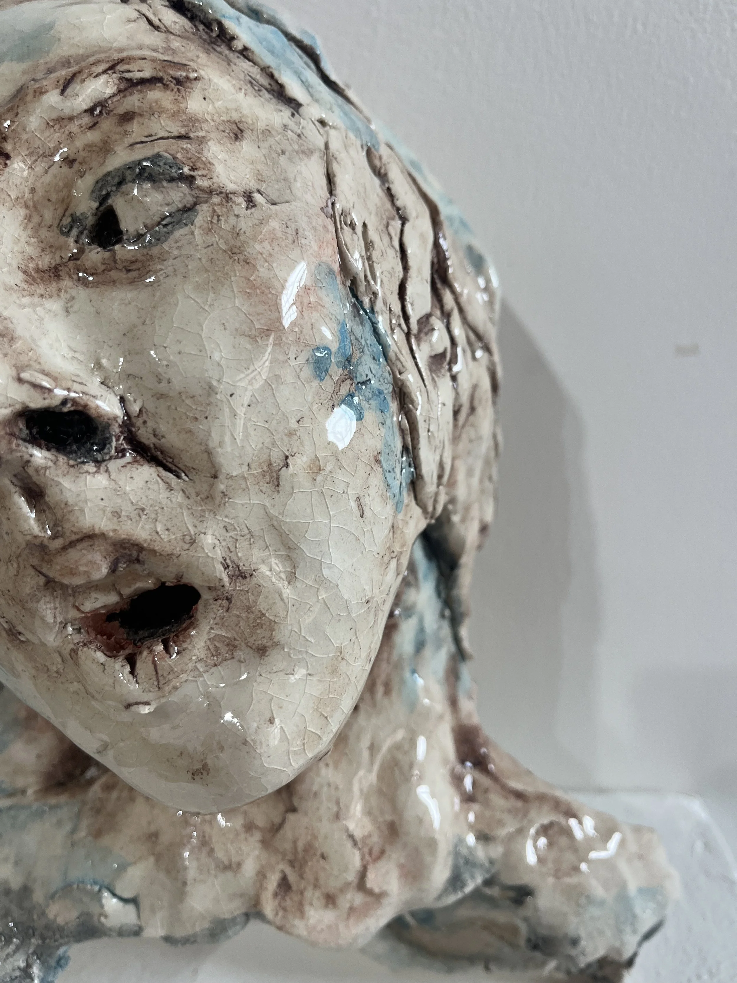 close up image of ceramic sculpture, properly displaying the cracks and details in the glaze