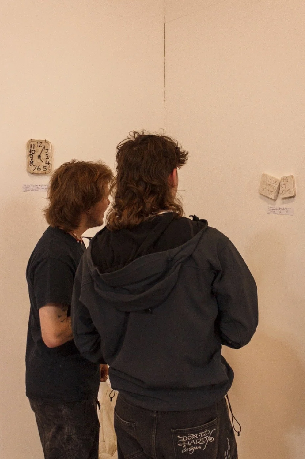 gallery visitors looking at work by Kat Hulmes