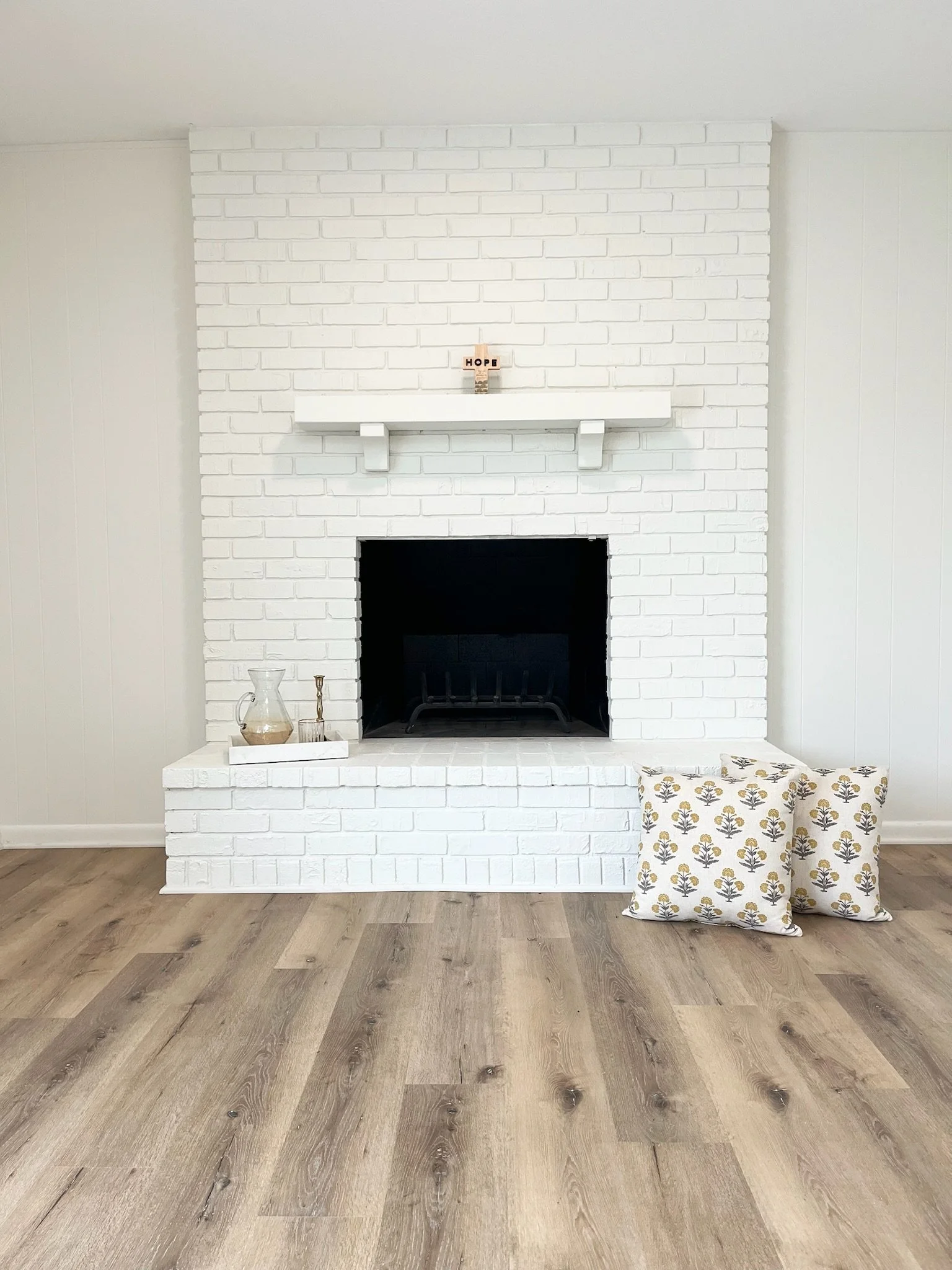 The kitchen flows to the cozy hearthroom where you can relax by the brick fireplace and gaze out over the expansive backyard. 