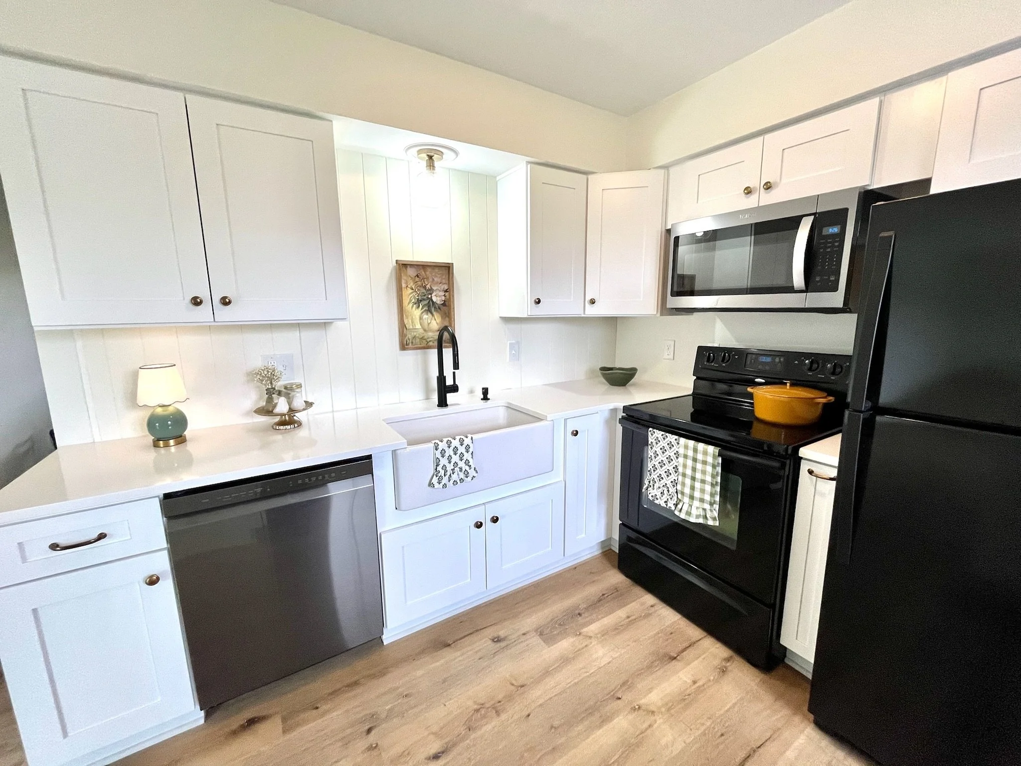 The heart of this home is its inviting kitchen which has brand new soft close cabinetry, quartz countertops, a sit down island, a charming apron sink, and stylish lighting. 