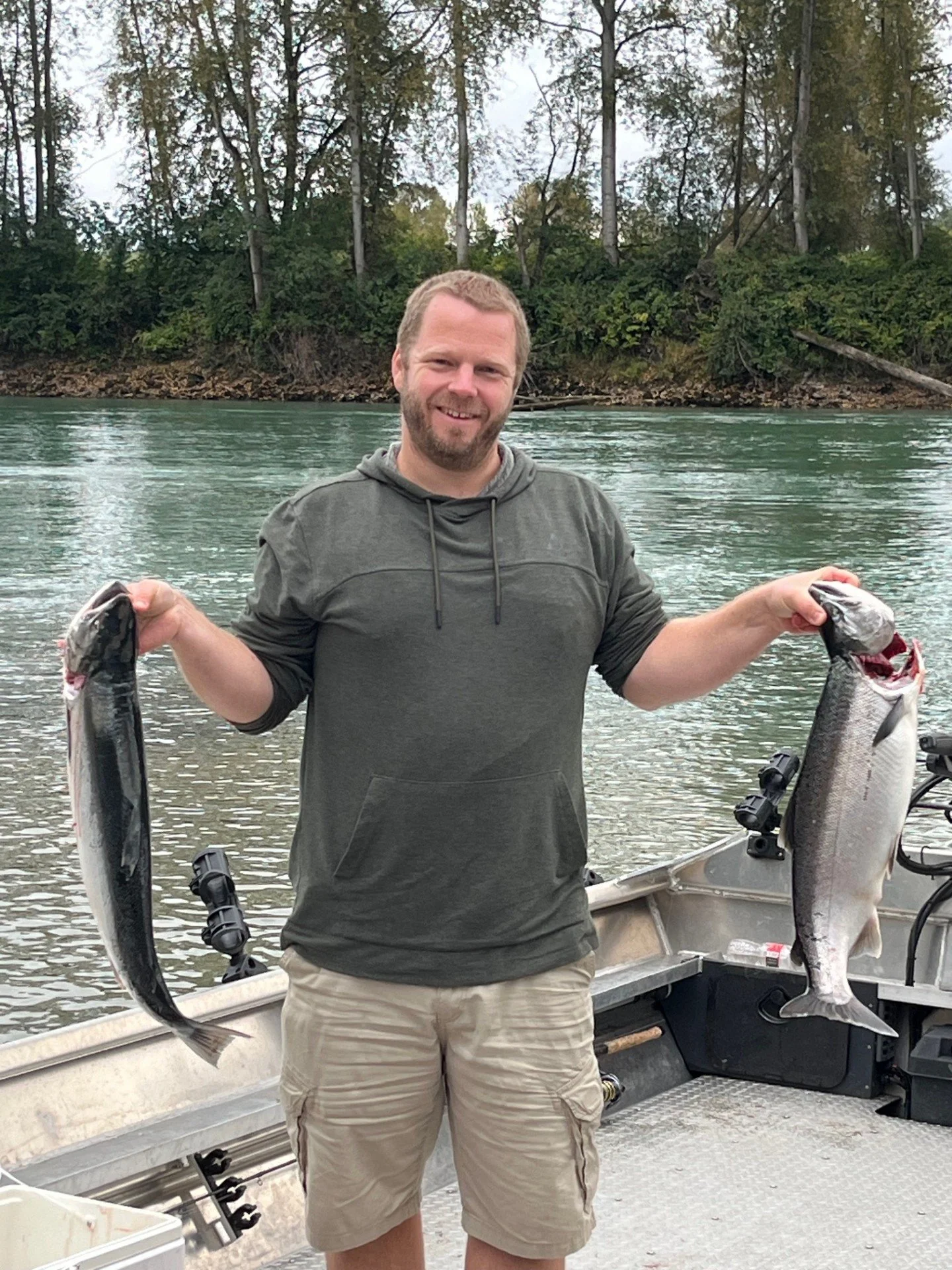 The owner of Wyman Guide Service with a pair of coho salmon.