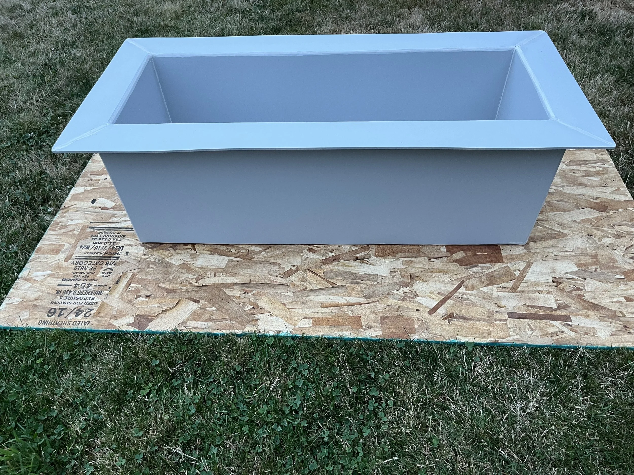 A double-wall, insulated fish box with drain fabricated and welded out of marine grade "dolphin gray" HDPE.