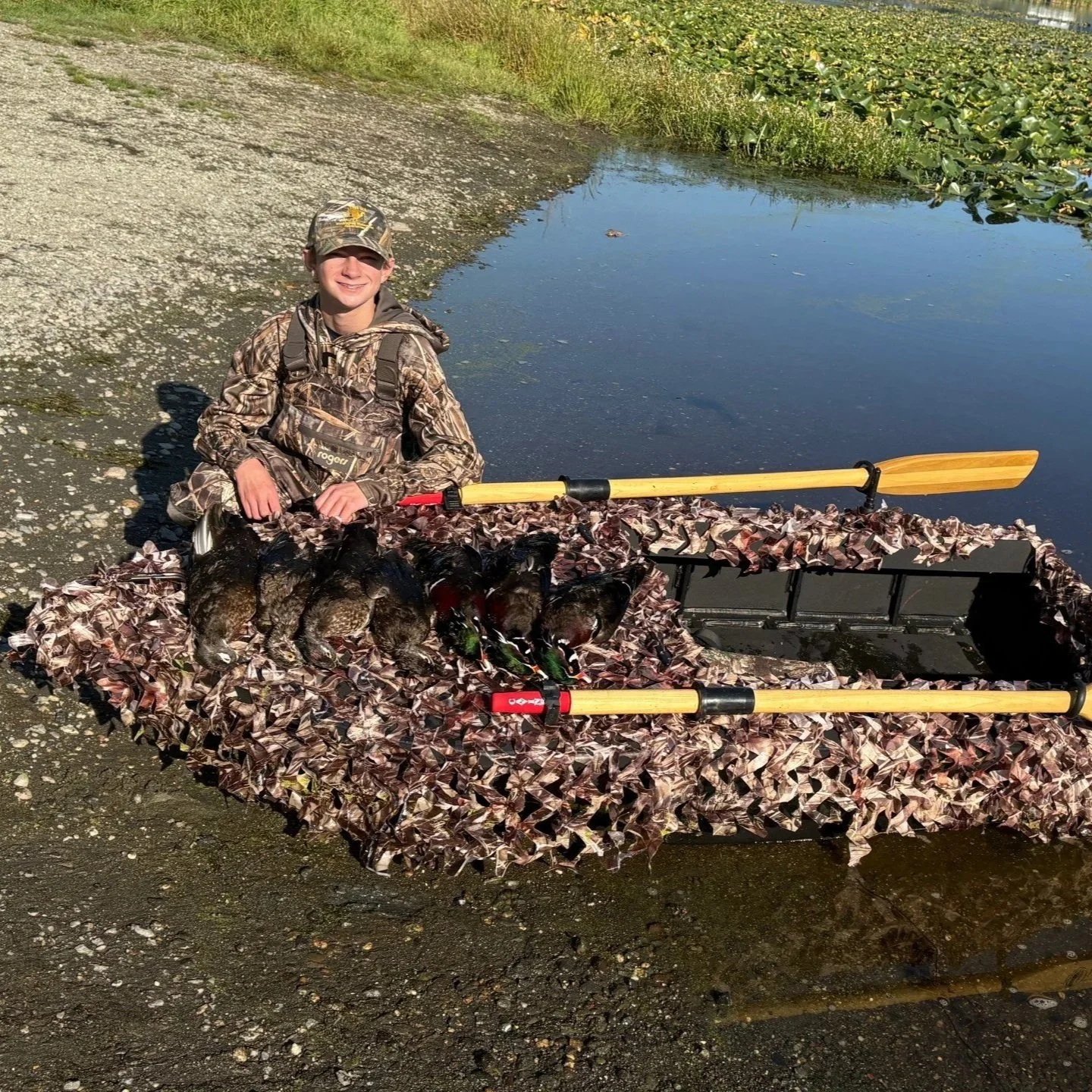 Tyler sporting a limit of wood ducks after using the welded HDPE layout boat.