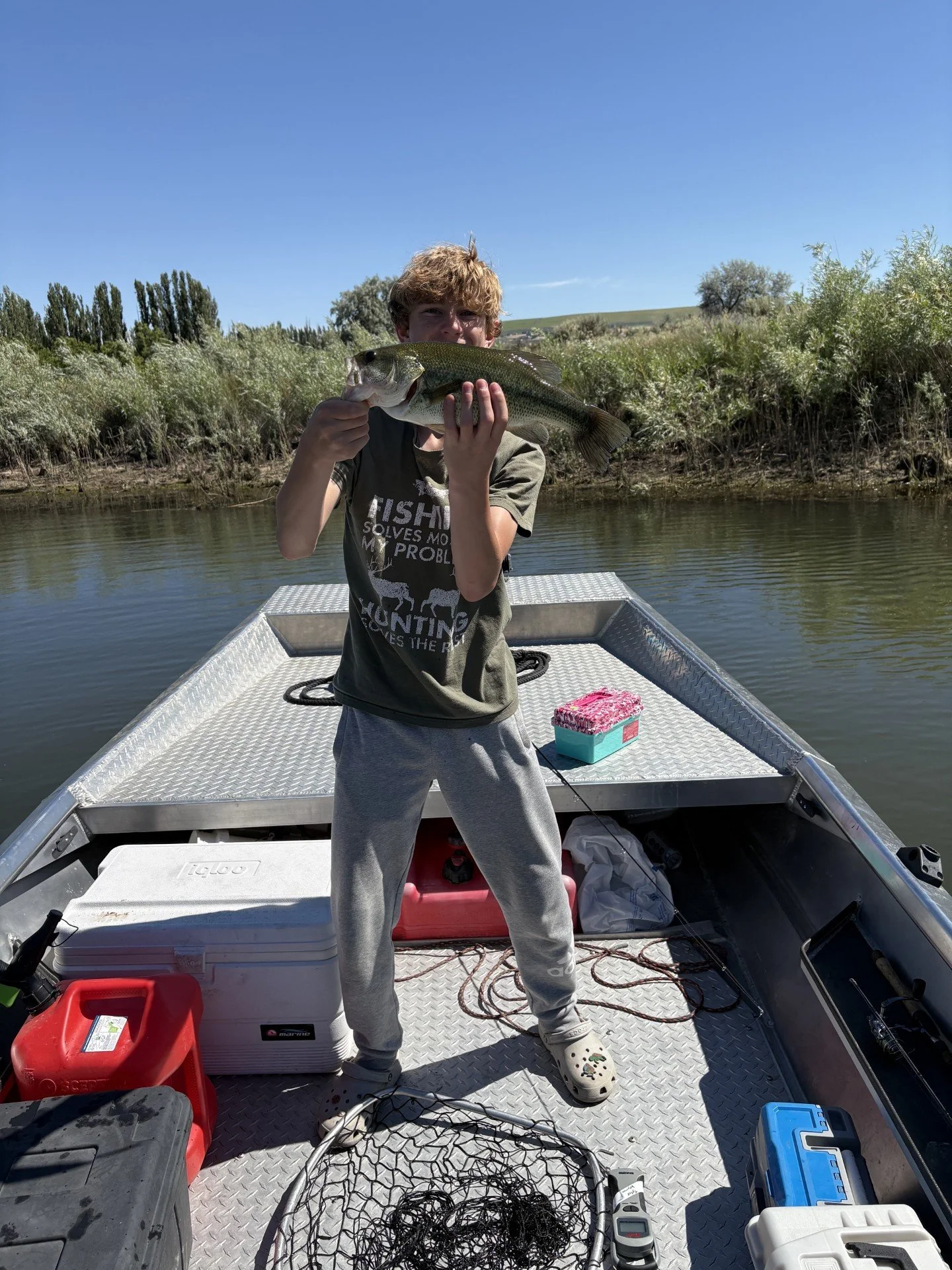 My son showing off a bass he caught.