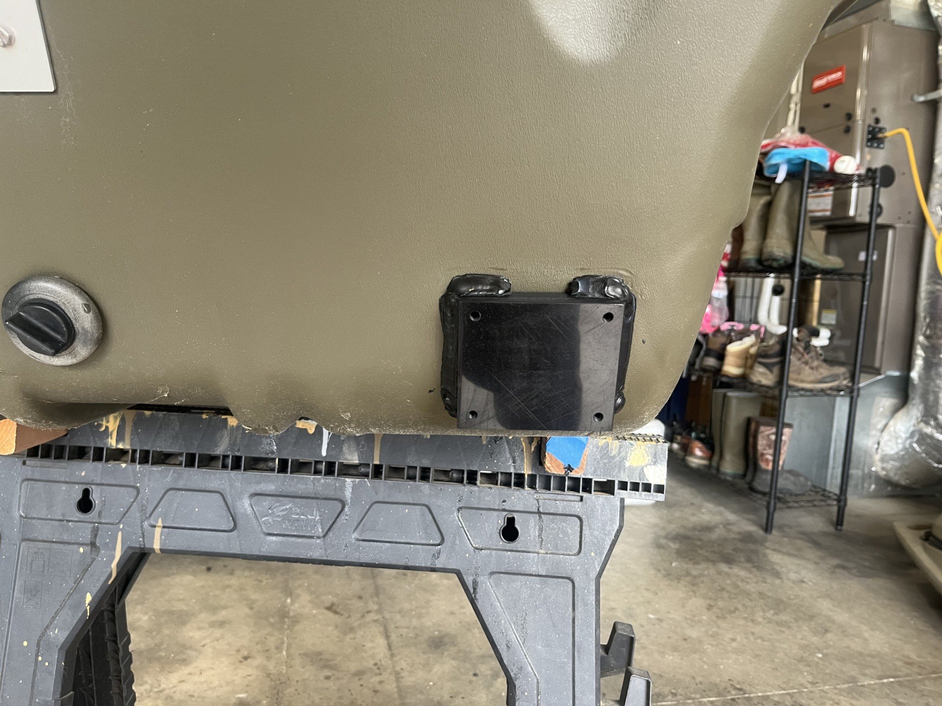 A transducer mount welded onto the back of a rotomolded HDPE boat.