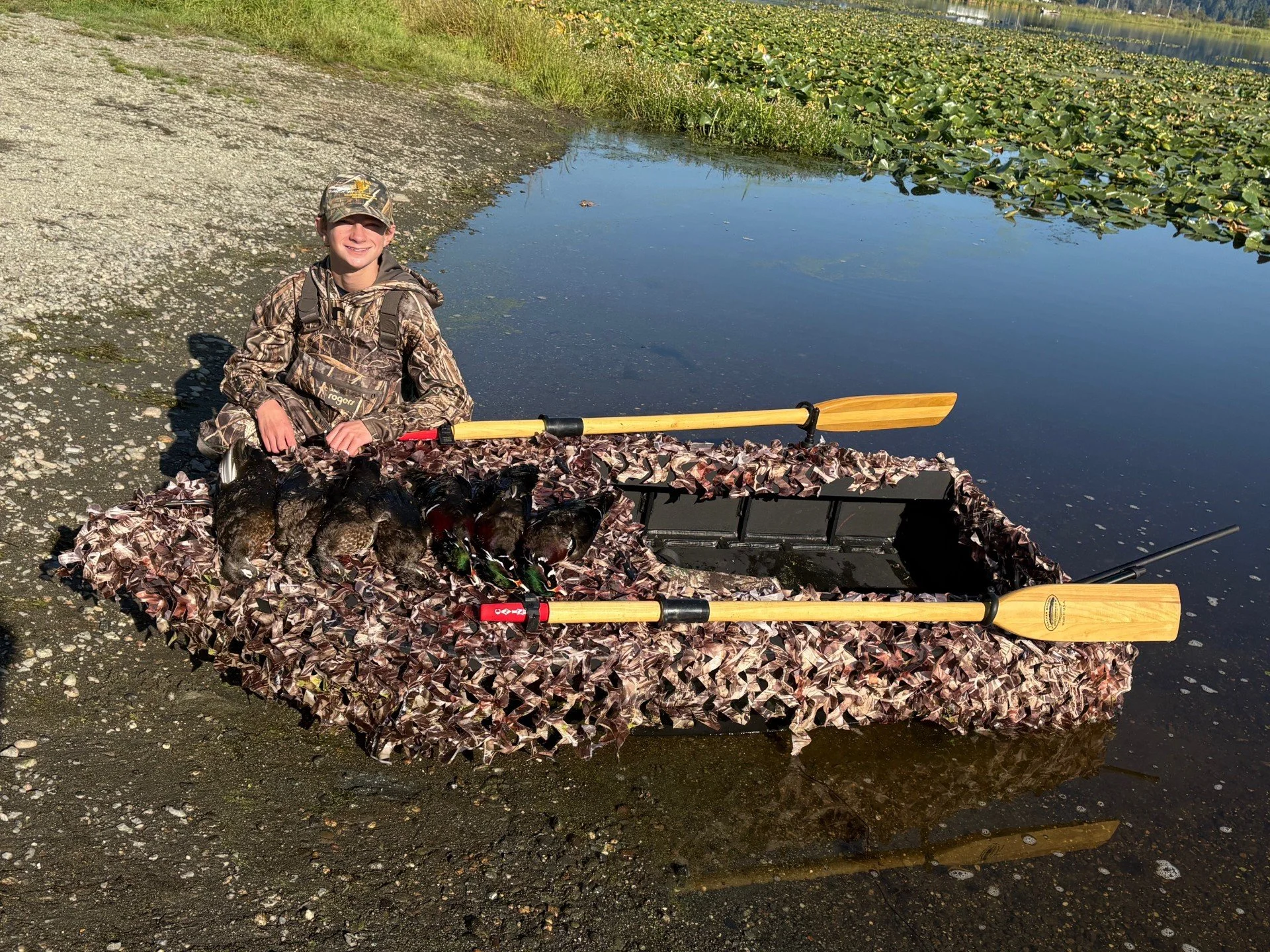 The son of Wyman Guide Service showing off his amazing 7-bird limit of wood ducks that he shot in Skagit Valley from their handmaid layout boat.