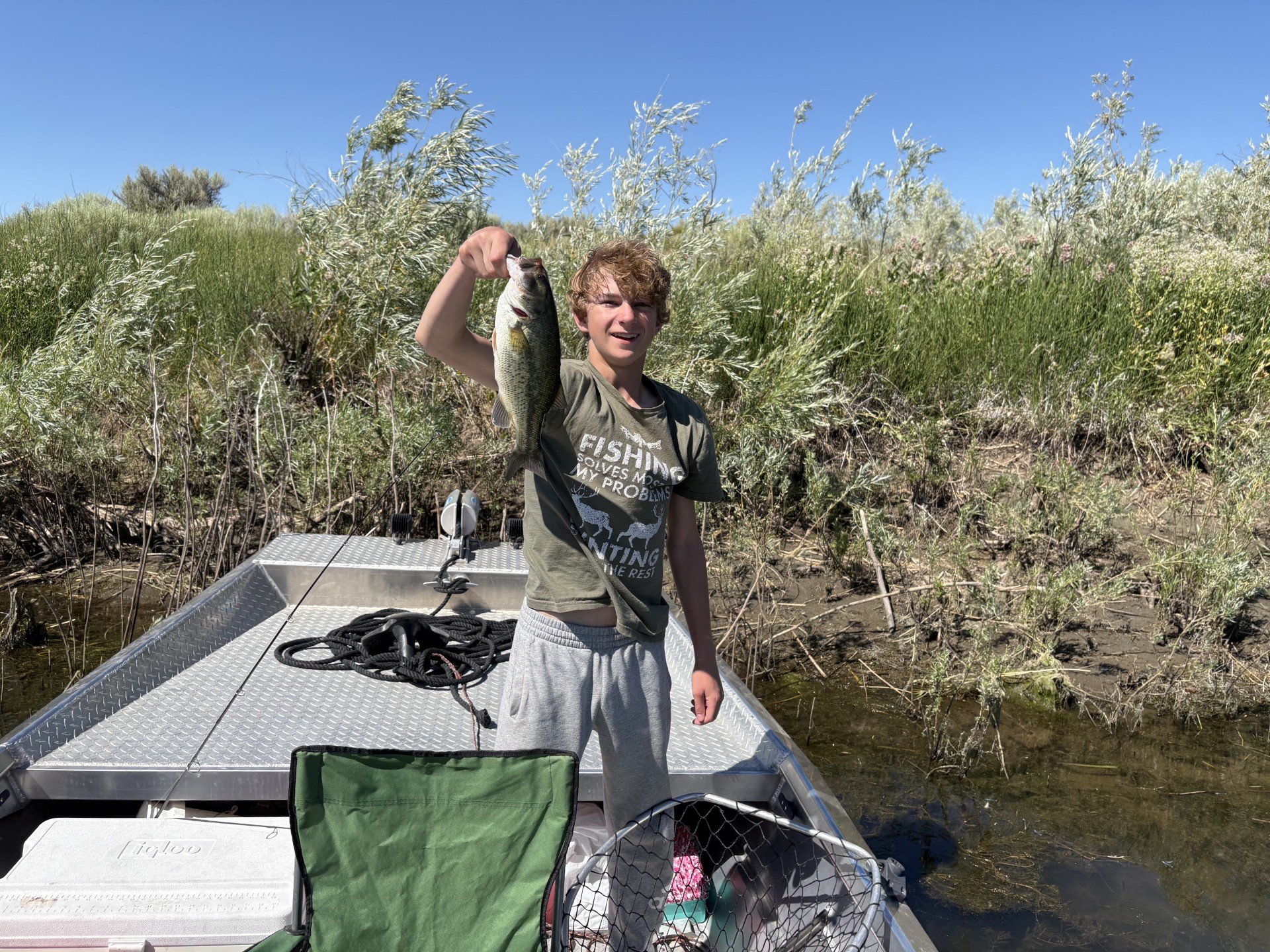 My son showing off a bass he caught.