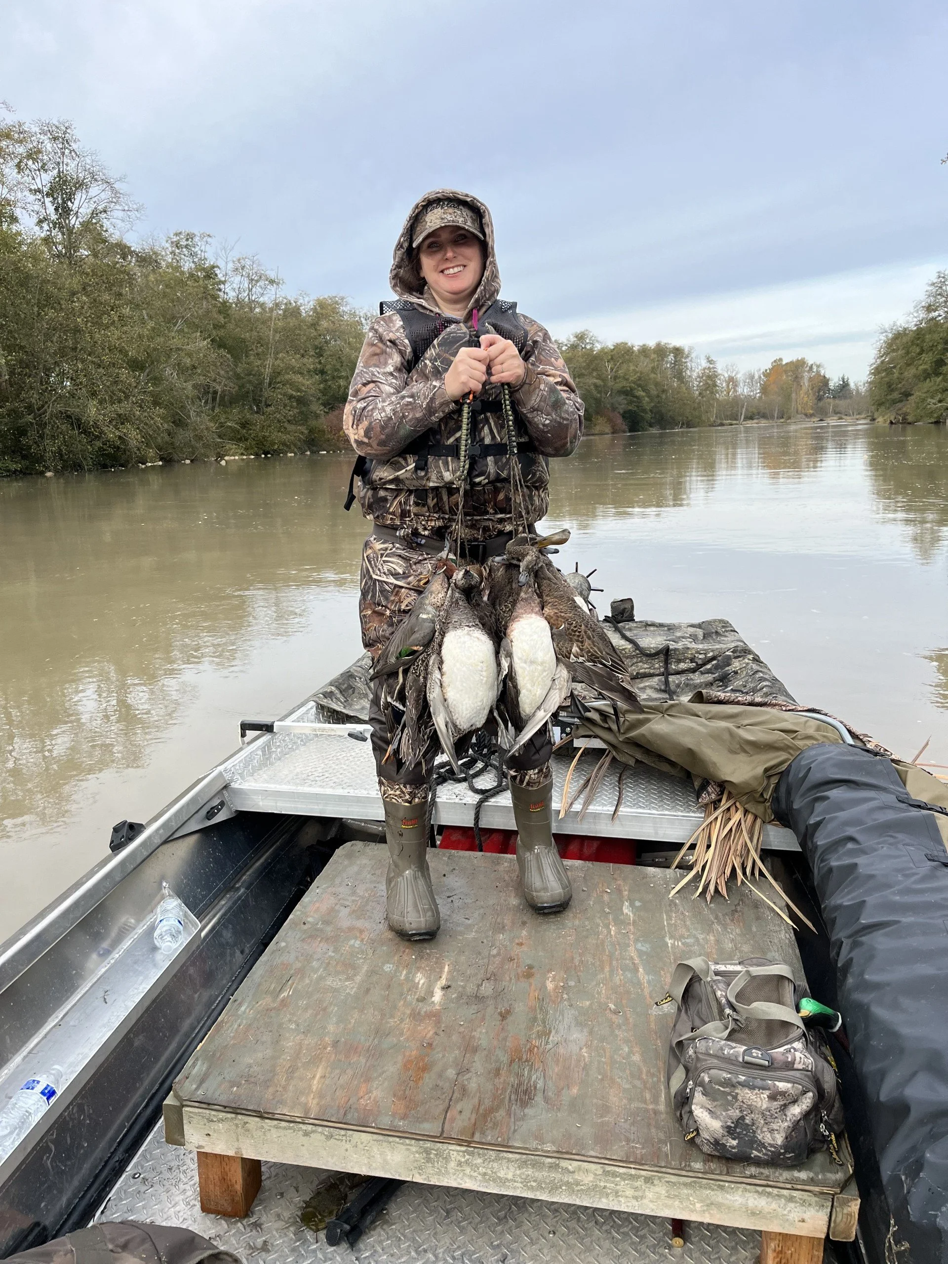 Your guide's wife looking pleased with the day's hunting trip while looking for ducks on the Skagit.